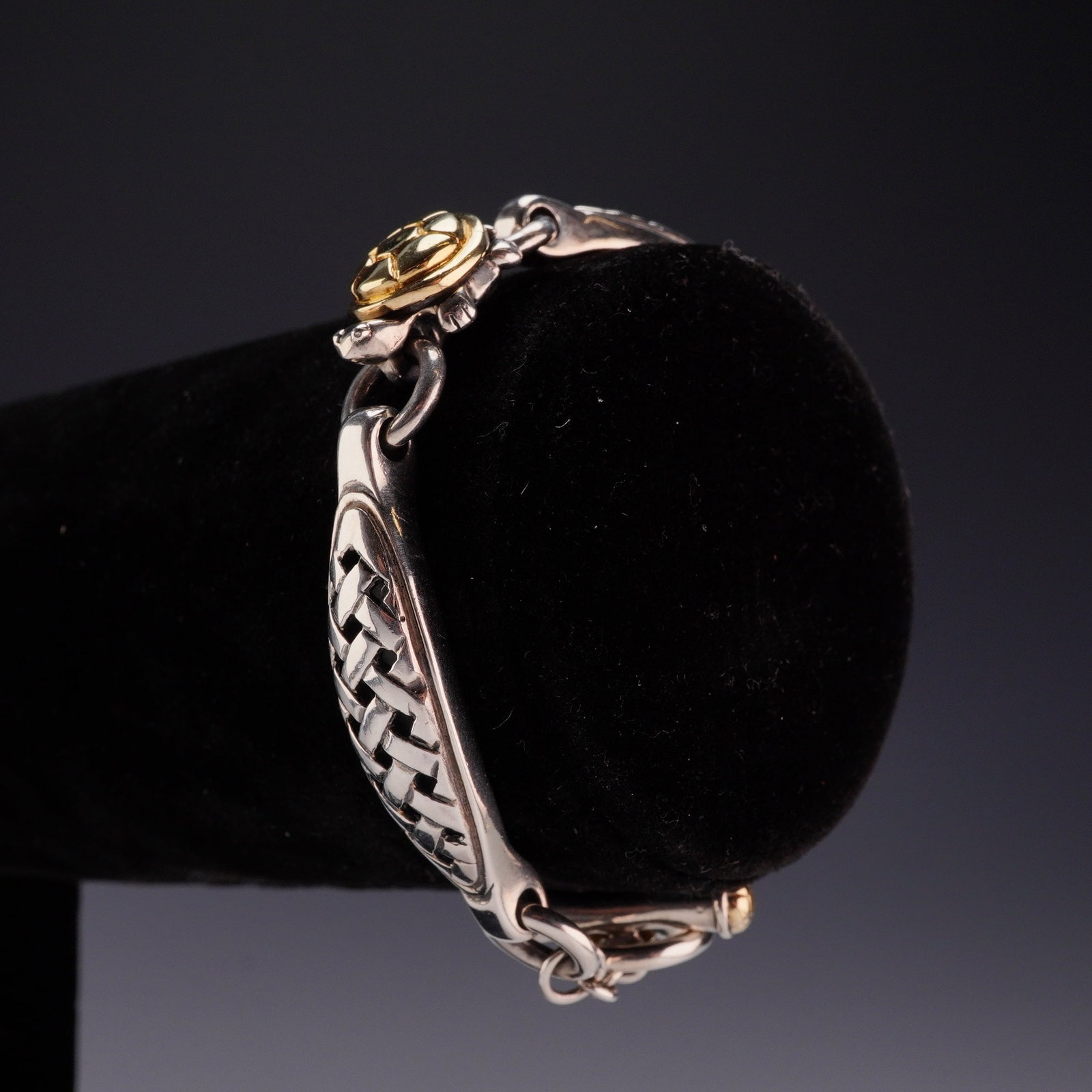 Saint Sterling Silver and 18K Yellow Gold Toggle Link Bracelet: This designer link bracelet is crafted from sterling silver and 18K yellow gold, bearing the maker mark for Saint. The bracelet is composed of three elongated, curved sterling silver links connected b