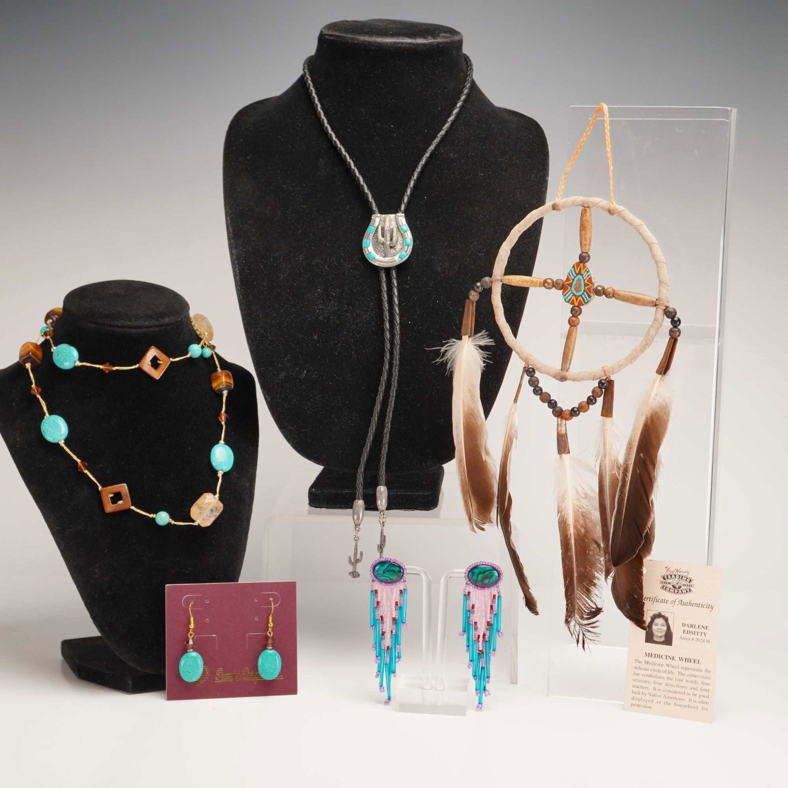 5pc Native American Style Custom Jewelry and Dreamcatcher Medicine Wheel: This lot features a five-piece collection of Native American style custom jewelry and decorative objects. The group includes a bolo tie, two pairs of earrings, a beaded necklace, and a medicine wheel.