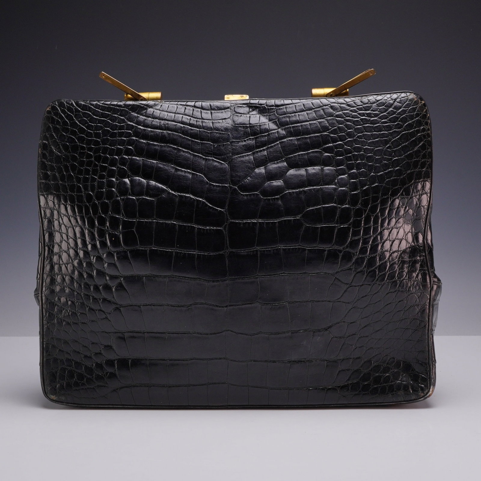 Rosenfeld Black Alligator Belly Skin Handbag with Red Leather Interior: This vintage structured frame handbag is crafted from genuine black alligator belly skin by the New York-based luxury maker Rosenfeld. The exterior features large, symmetrical scales typical of