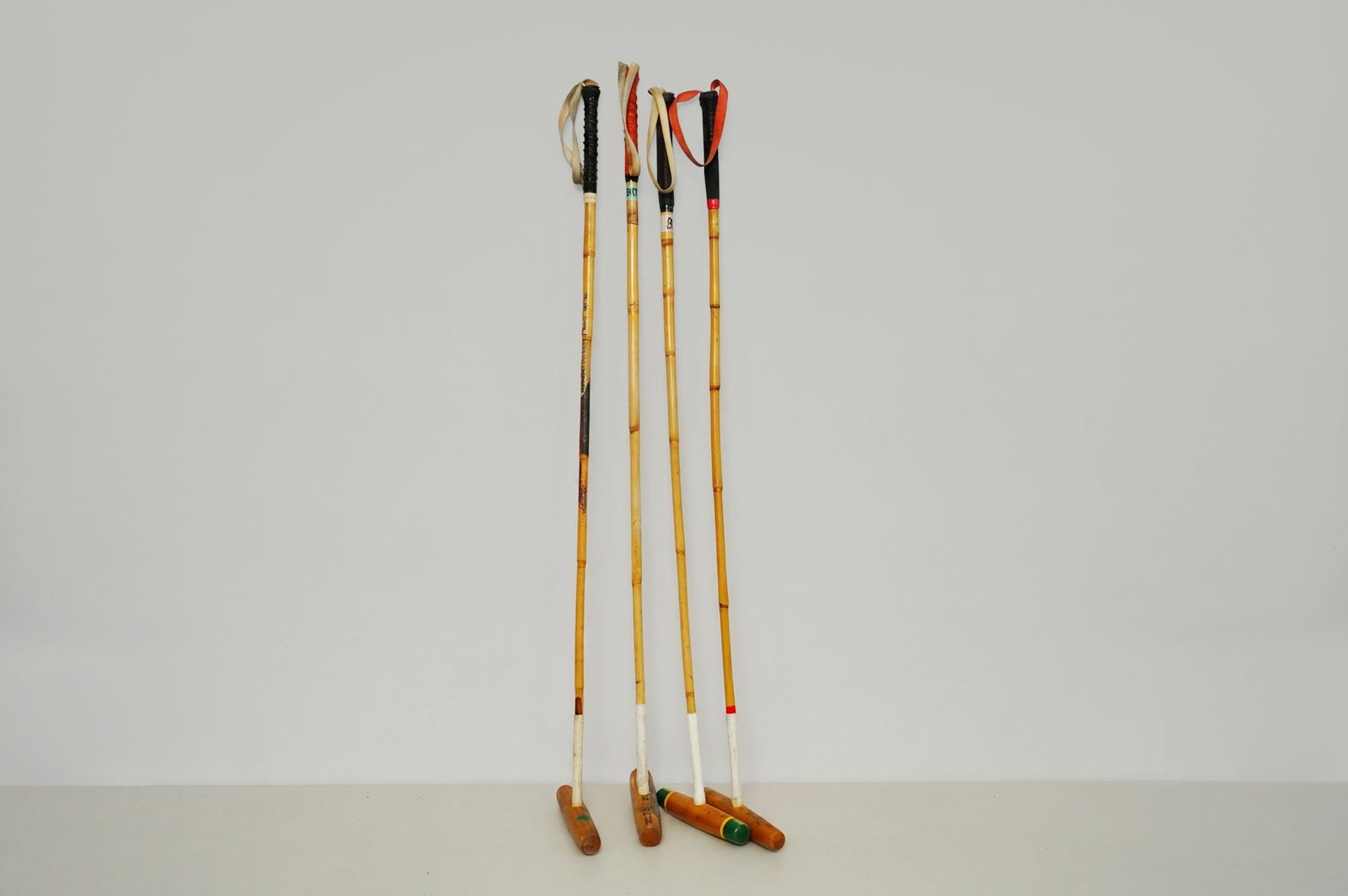 4pc Nano's and LaMartina Wooden Polo Mallets: A well-matched group of four vintage wooden polo mallets by Nano's and La Martina, two respected makers known for producing durable, competition-grade equipment. Each mallet features a 51.5-inch shaft