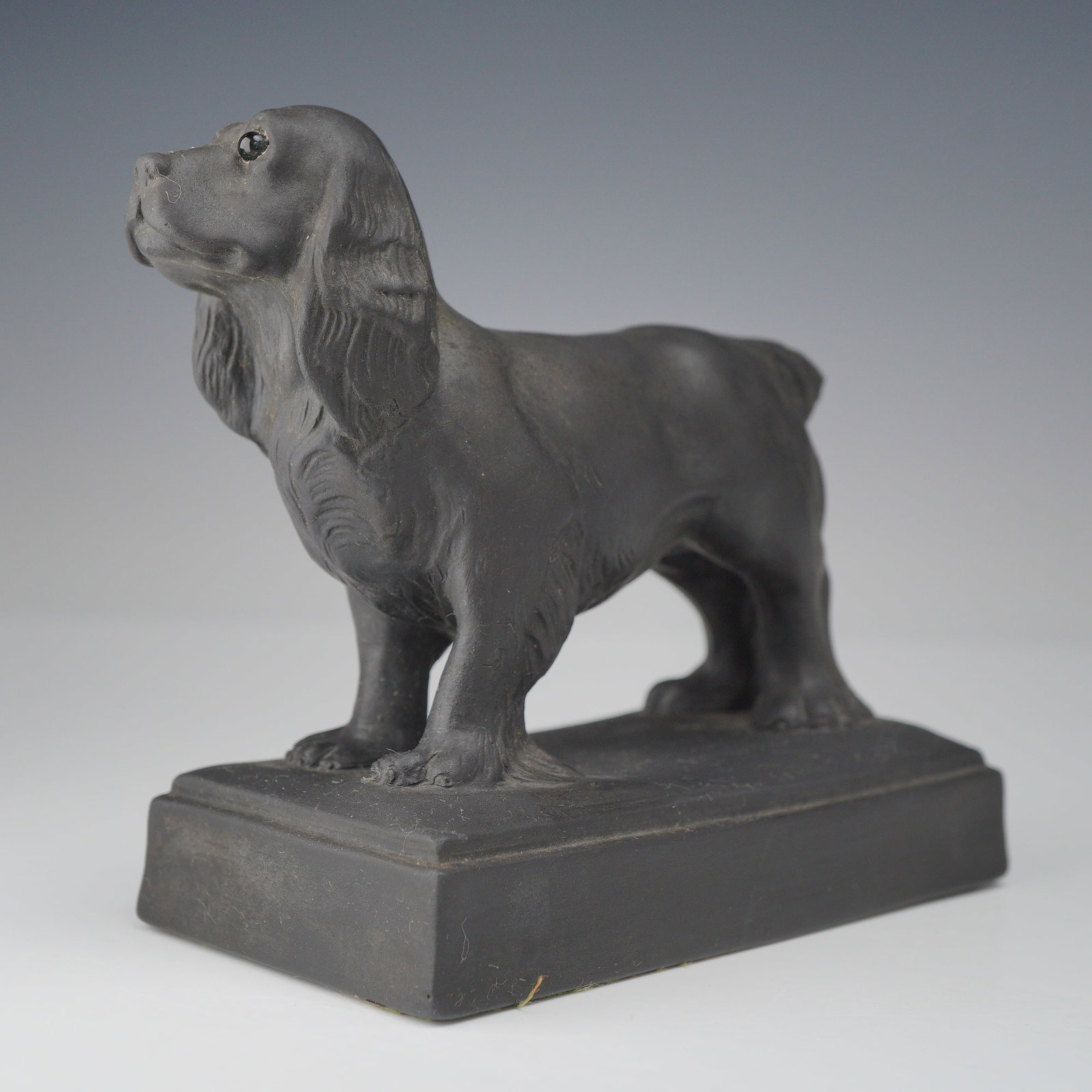 Wedgwood Black Basalt Figurine, Cocker Spaniel: This figurine is a Wedgwood black basalt model of a standing cocker spaniel dog. The figure is realistically modeled standing on a rectangular plinth base, featuring the breed's characteristic long, w