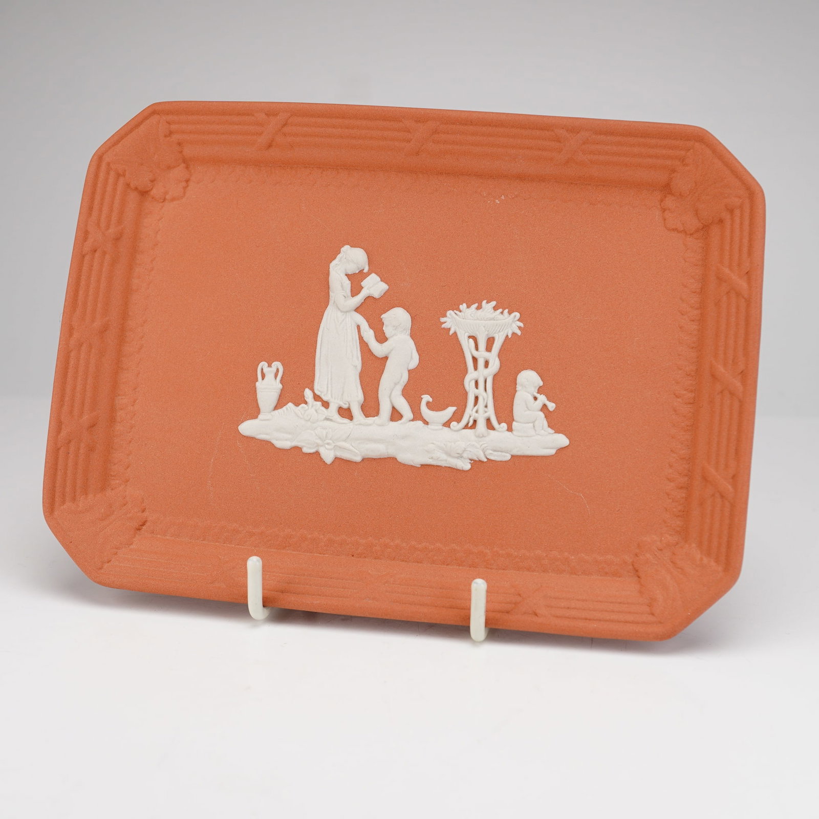 Wedgwood Terracotta and White Jasperware Rectangular Trinket Tray: A Wedgwood Jasperware rectangular trinket tray featuring a terracotta-colored stoneware body with white bas-relief decoration. The central sprigged neoclassical scene depicts a standing woman reading 