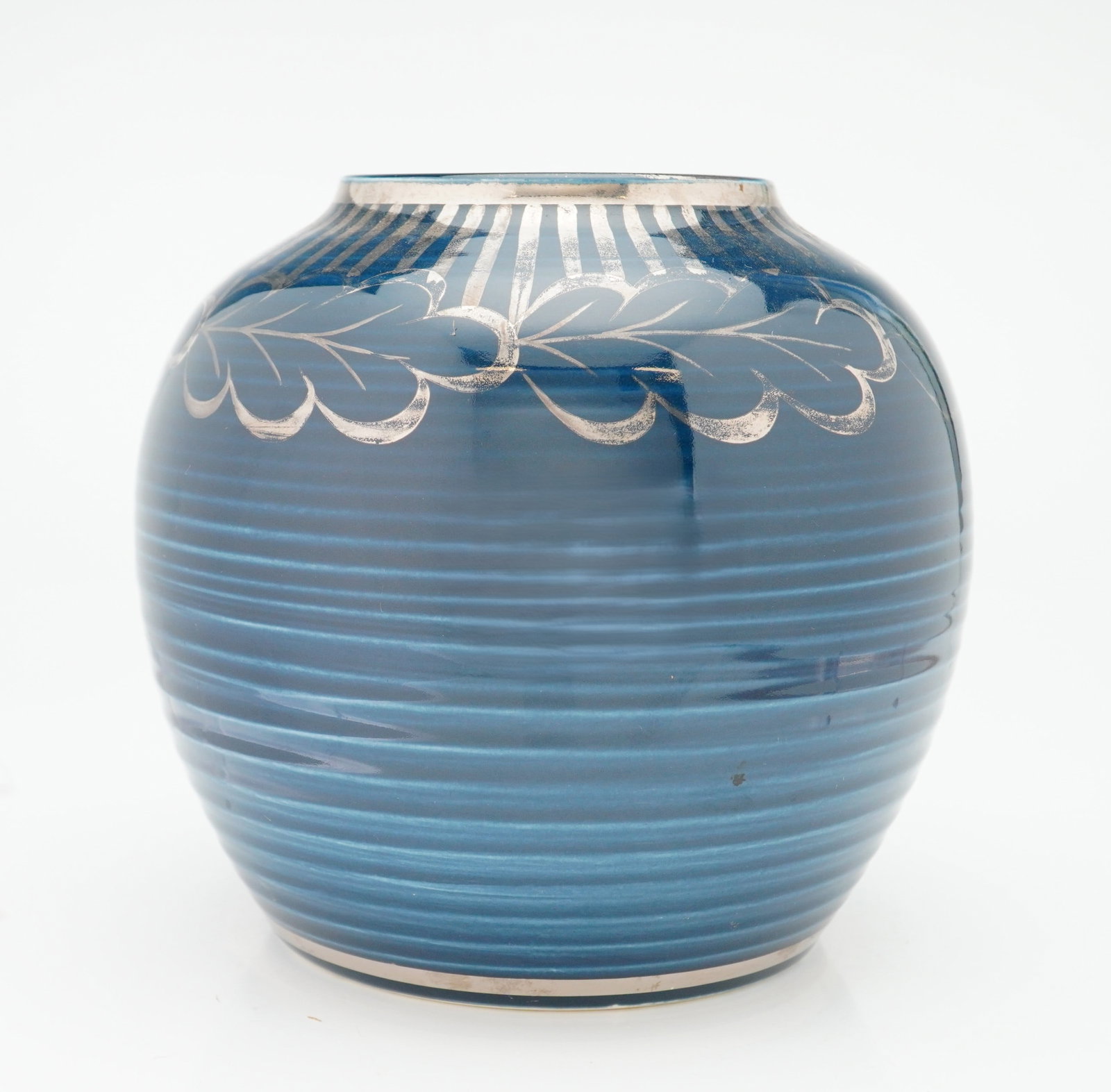 Two Wedgwood Blue Veronese Ceramic Vases with Silver Overlay: This globular ceramic vase is identified as part of the Weller Ware Rubin collection. The vessel features a horizontally ribbed body finished in a deep cobalt blue glaze. It is decorated with a silver