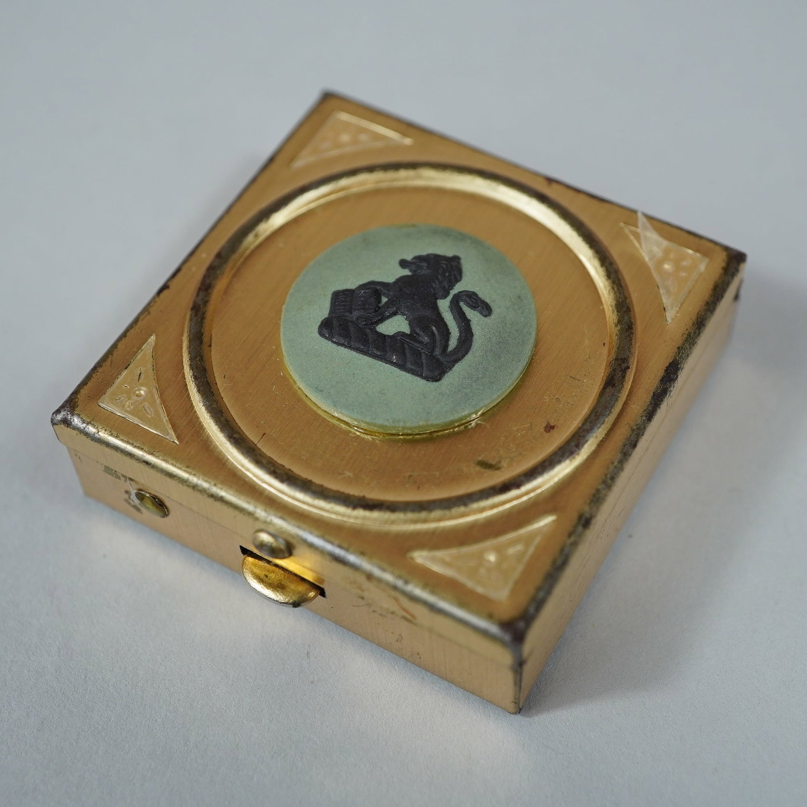 Wedgwood Gold-Toned Metal Pill Box with Lion of Saint Mark Medallion: A vintage square-form accessory box suitable for use as a pill or stamp box. The box is constructed from gold-toned metal with a hinged lid. The center of the lid features a circular green composition