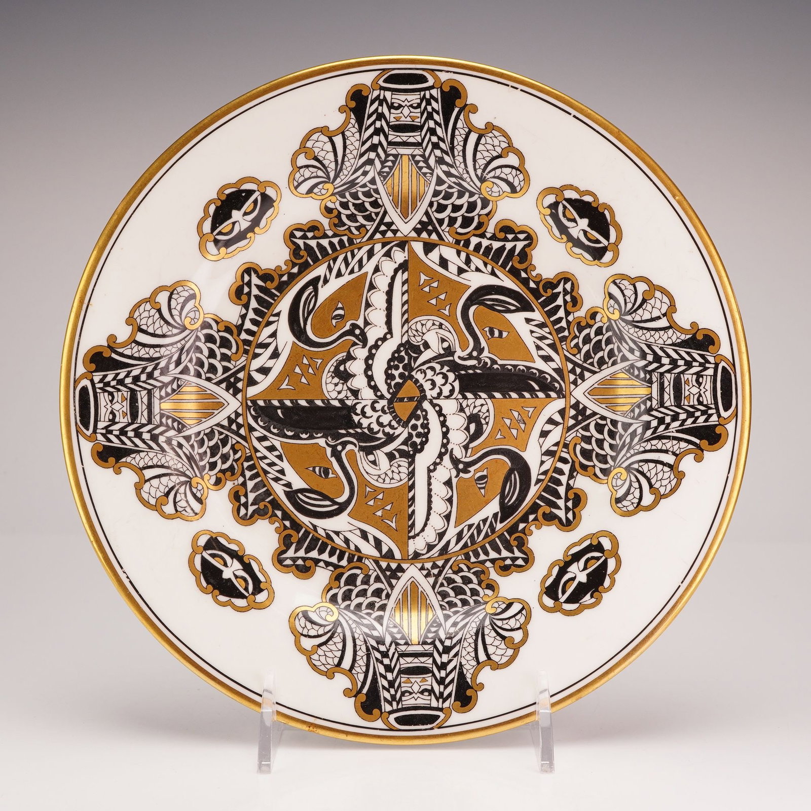 Wedgwood Porcelain Decorative Plate: A circular porcelain decorative plate manufactured by Wedgwood in England. The piece is decorated with a complex, stylized geometric pattern in black transfer-print with hand-applied gold luster accen