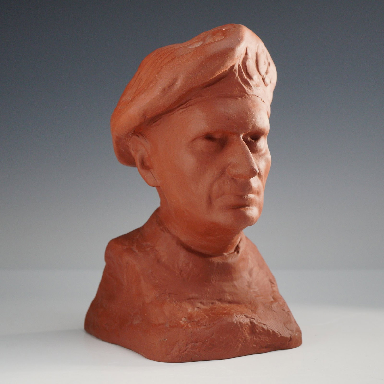 Wedgwood Red Stoneware Trial Bust of Field Marshal Bernard Montgomery, ca. 1975: This Wedgwood dark brown-red stoneware portrait bust depicts Field Marshal Bernard Montgomery, also known as Monty. The sculpture is realistically modeled, showing the subject wearing his signature be