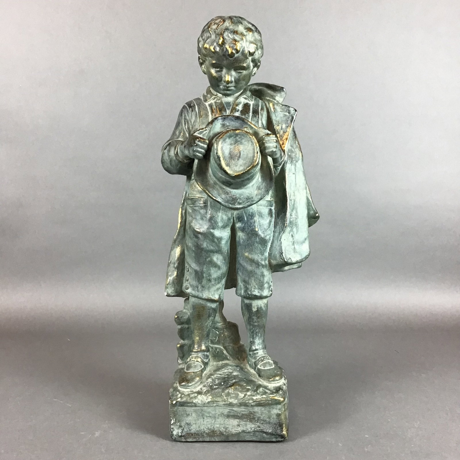 Cast Metal Figure of a Boy Holding a Hat (1 of 4)