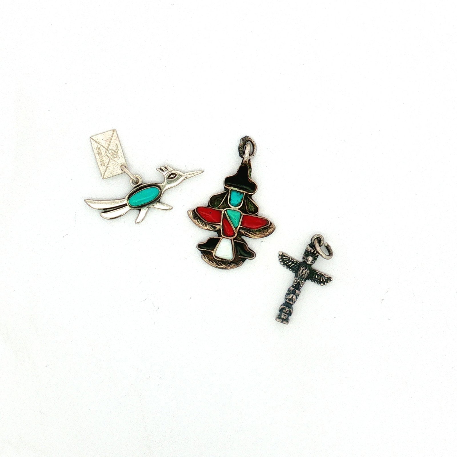 3pc Sterling Silver Southwestern and Native American-Inspired Charms: A collection of miniature sterling silver charms featuring Native American and Southwestern designs. Includes a Zuni knife-wing charm inlaid with turquoise, coral, onyx, and mother of pearl, a roadrun