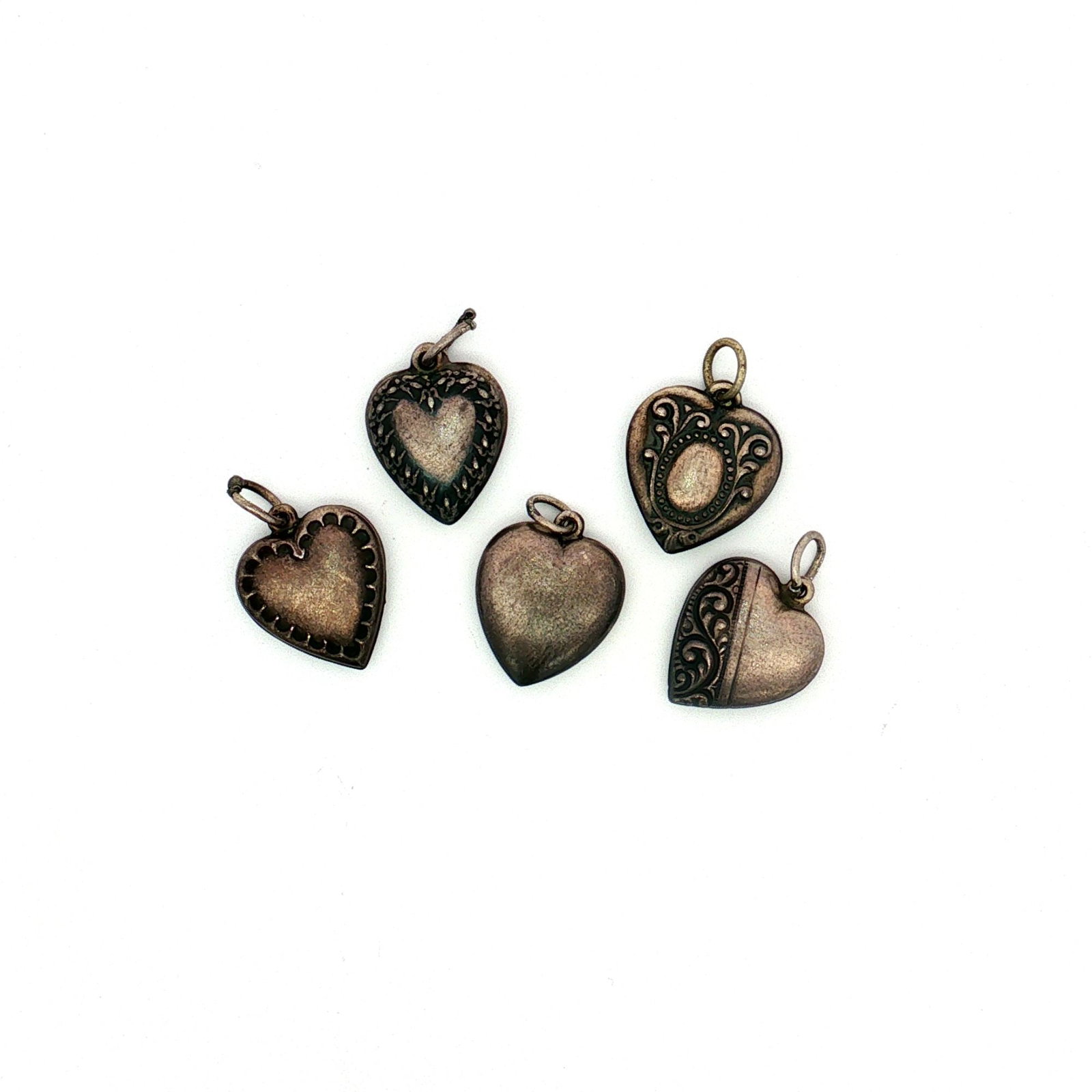 5pc Sterling Silver Heart Charms: A five piece collection of sterling silver heart charms featuring various designs, including scrollwork, a scallop-patterned frame, and a floral-style frame. Each charm is personalized and marked Ster
