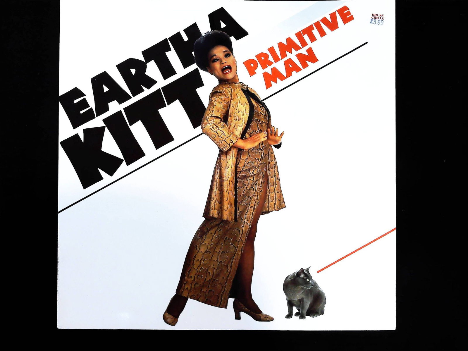 Eartha Kitt Primitive Man 12-Inch Vinyl Maxi-Single ARISTA 1983: A single 12-inch vinyl maxi-single record by Eartha Kitt, titled Primitive Man. The black vinyl disc is housed in its original printed cardstock picture sleeve featuring a photographic portrait of Kit
