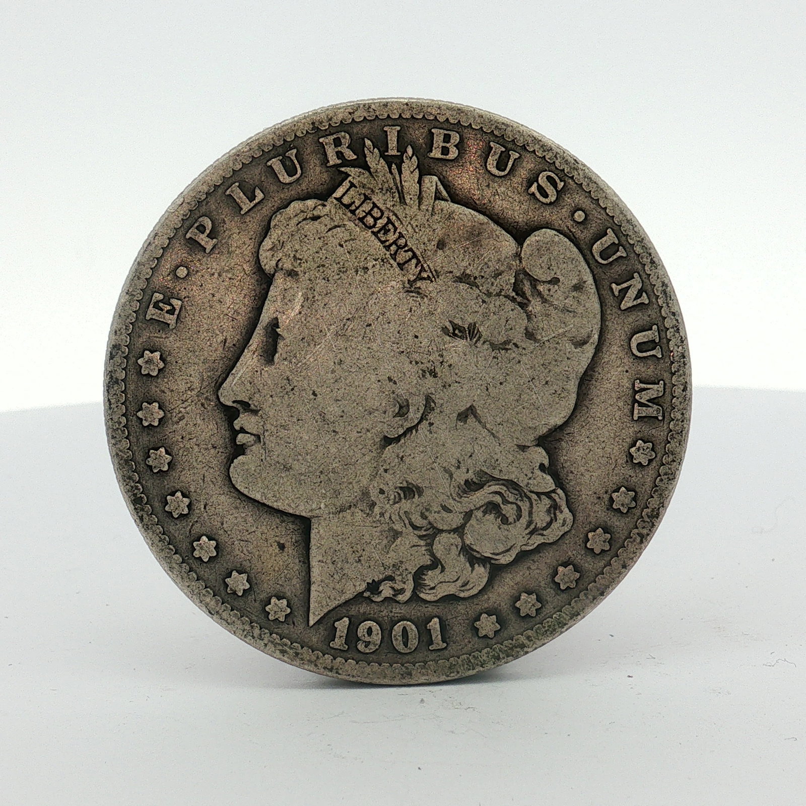 1901-S US One Dollar Morgan Silver Dollar, Circulated: This US 1901-S Morgan silver dollar is a circulated specimen struck at the San Francisco Mint. The coin features the Morgan dollar design and is composed of 90% silver with a .900 fineness. The revers