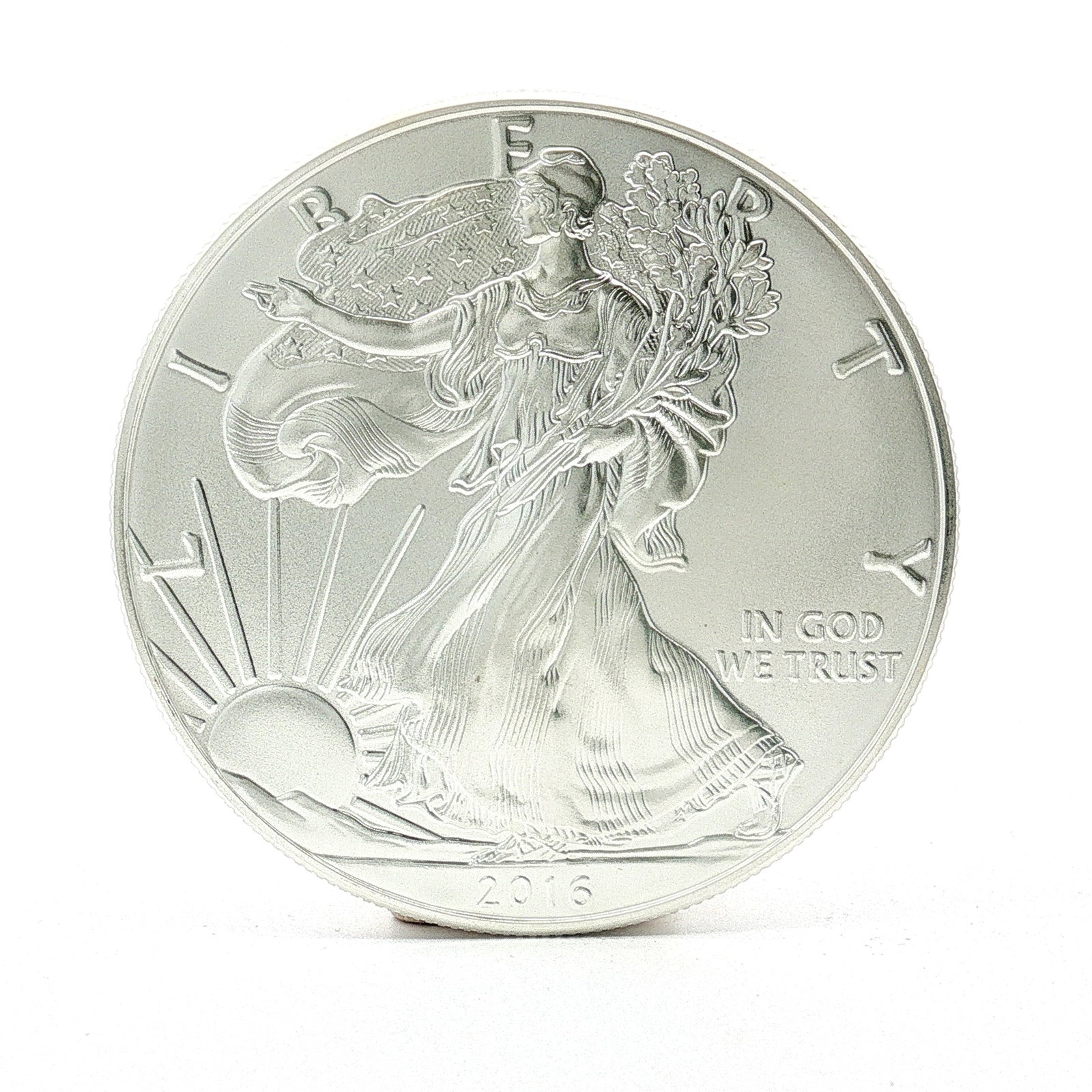 2016 U.S. American Silver Eagle One Dollar Coin: Designed with Obverse of Walking Liberty with Liberty in God We Trust 2016; reverse has heraldic eagle with shield, United States of America with 1oz. Fine Silver One Dollar. Dimensions: 40.6mm Date o
