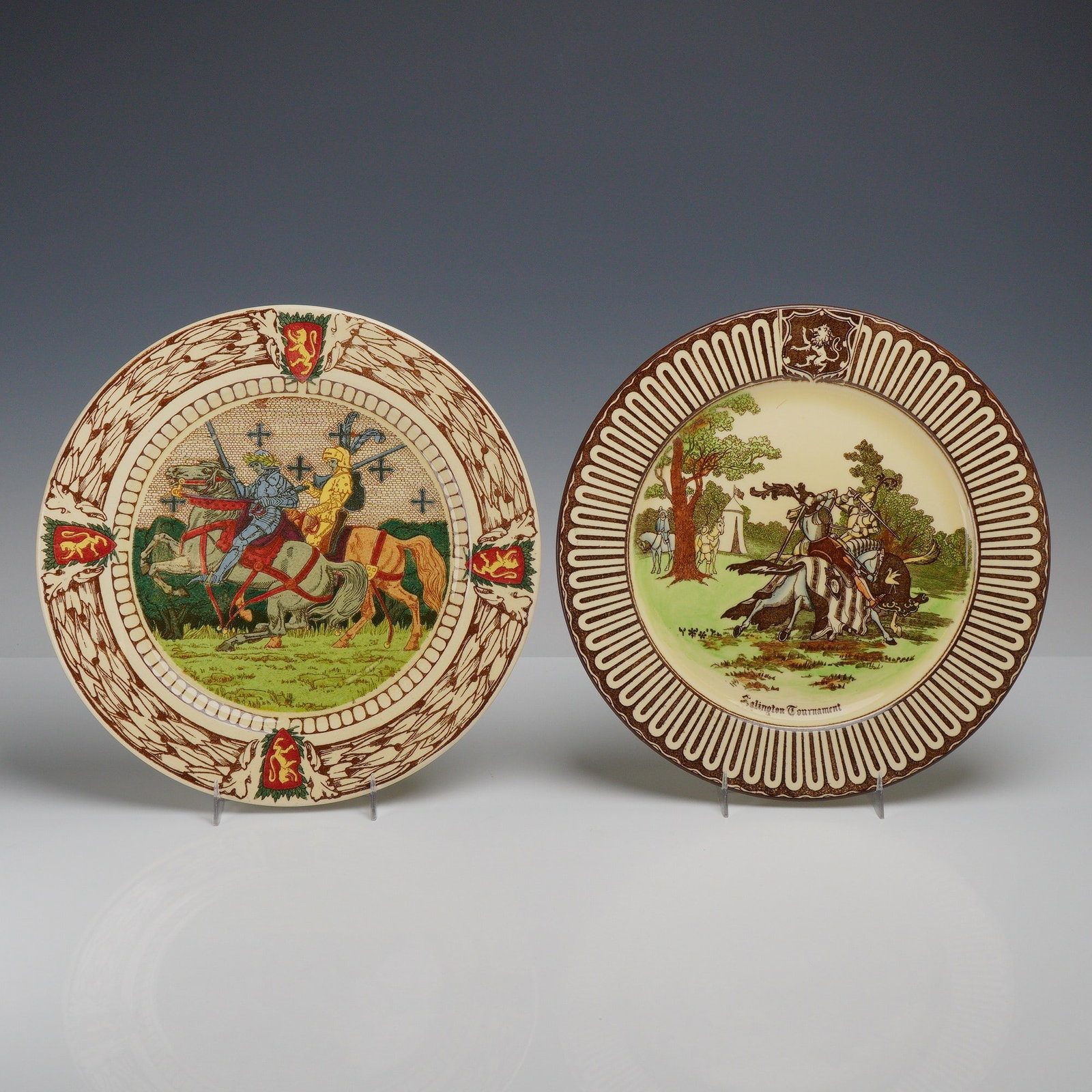 2pc Royal Doulton King Arthur's Knights and Royal Eglinton Plates: This pair of Royal Doulton earthenware Seriesware plates features scenes of medieval pageantry. The first, from the King Arthur's Knights series (D2961), depicts two armored knights jousting against a