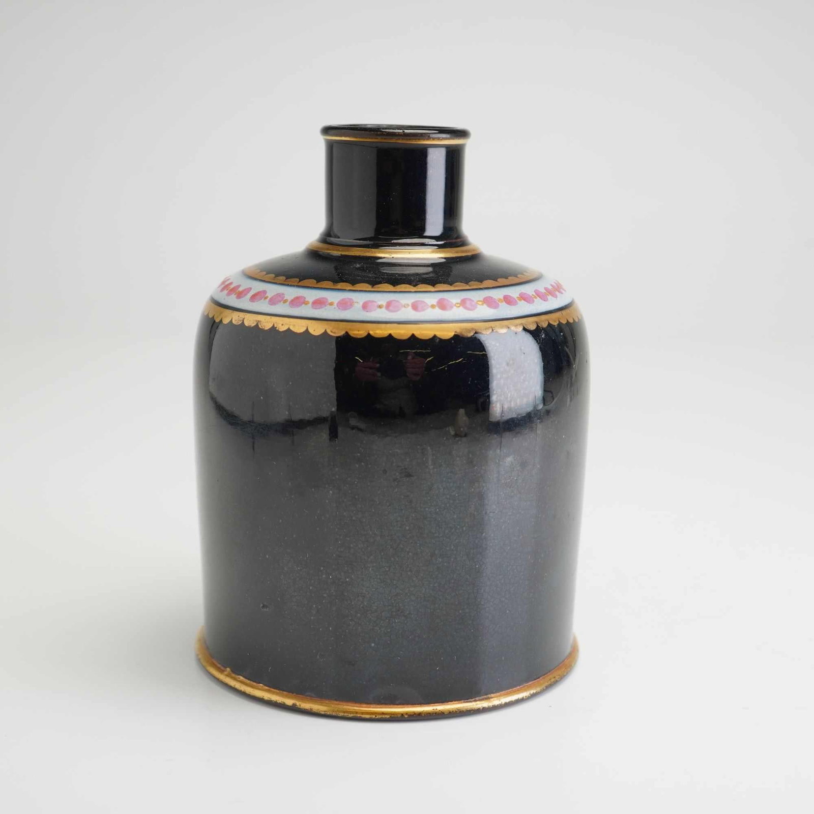Wedgwood Black Basalt and Enamel Inkwell Vase: This black basalt inkwell vase was manufactured by Wedgwood circa 1880. The vessel features a cylindrical body with a rounded shoulder, a short upright neck, and a slightly flared rim. It is decorated