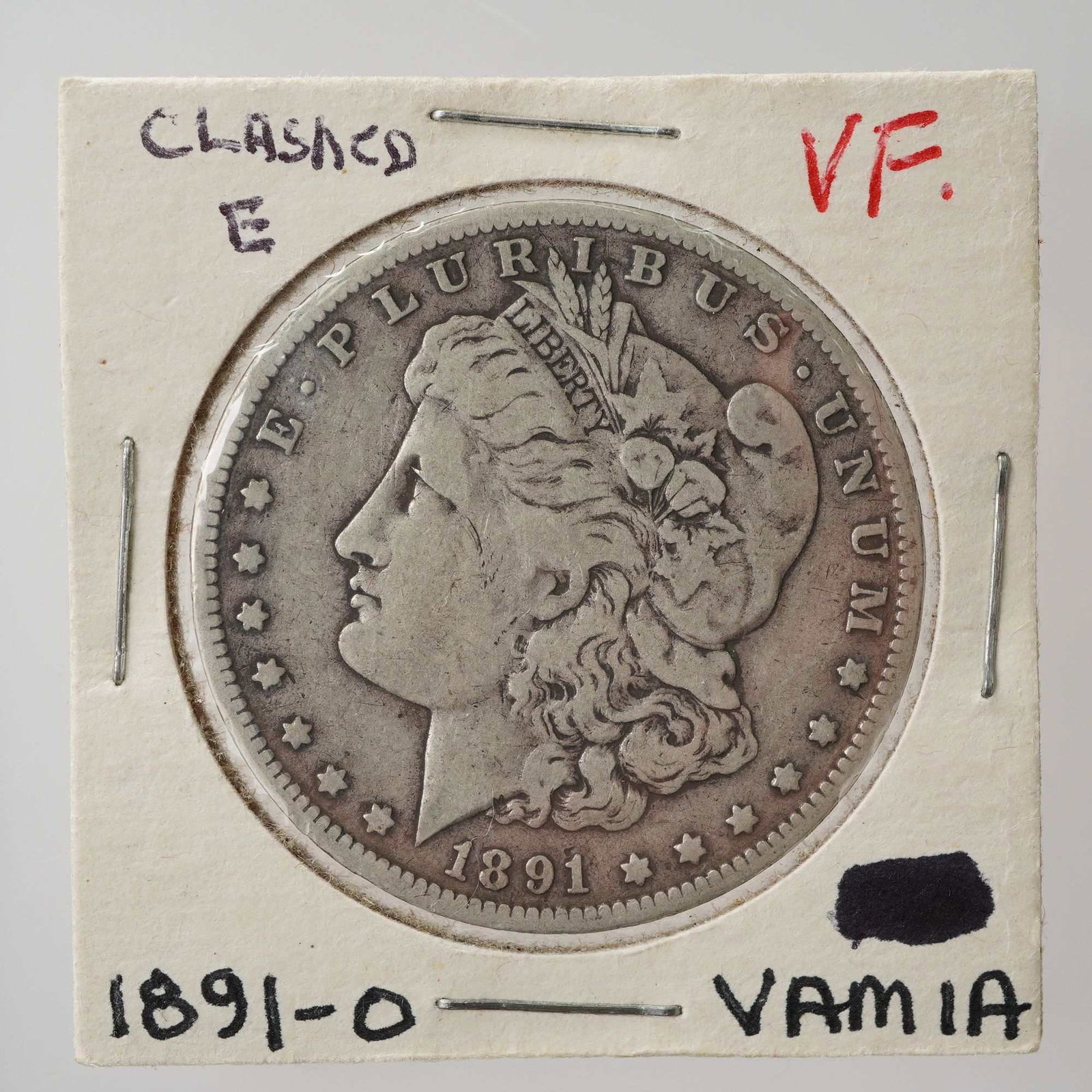 1891-O Morgan Silver Dollar: Struck at the New Orleans Mint, this silver dollar features the classic Liberty Head design on the obverse, depicting Lady Liberty wearing a Phrygian cap adorned with wheat and cotton, with the word L