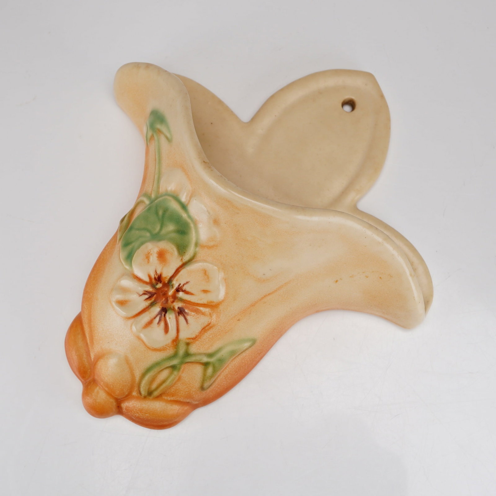 Weller Pottery Panella Wall Pocket: Produced by Weller Pottery, this Weller Panella Wall Pocket is an earthenware art pottery vessel in the Panella pattern, which was introduced circa 1938. The decoration consists of relief-molded eleme