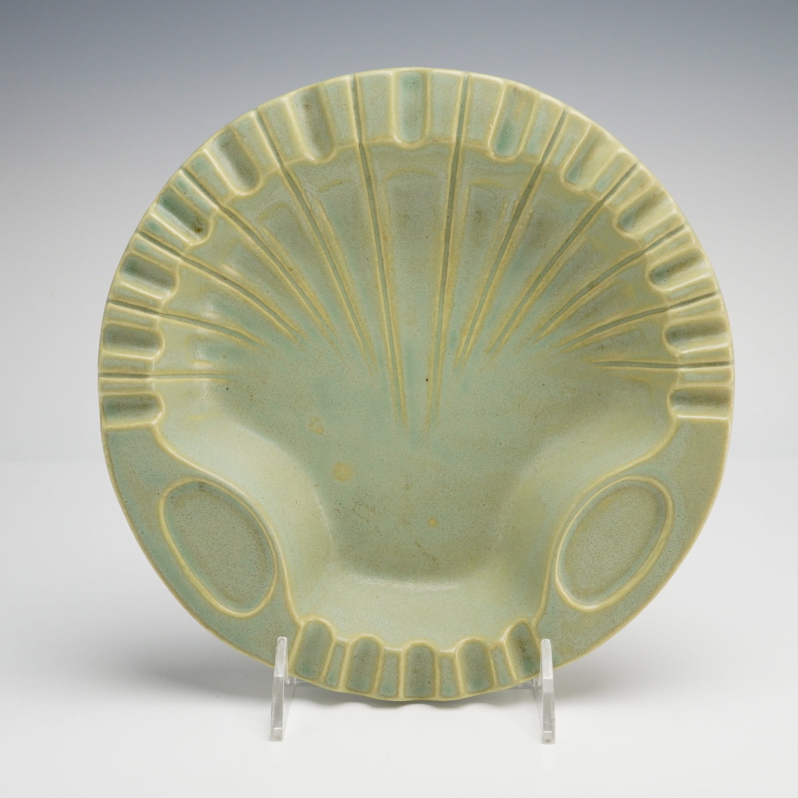 Roseville Pottery Shell Pattern Ashtray: Produced by Roseville Pottery of Zanesville, Ohio, this earthenware art pottery ashtray is shaped like a shell. The form features a radiating ribbed interior, a scalloped rim with multiple integrated 