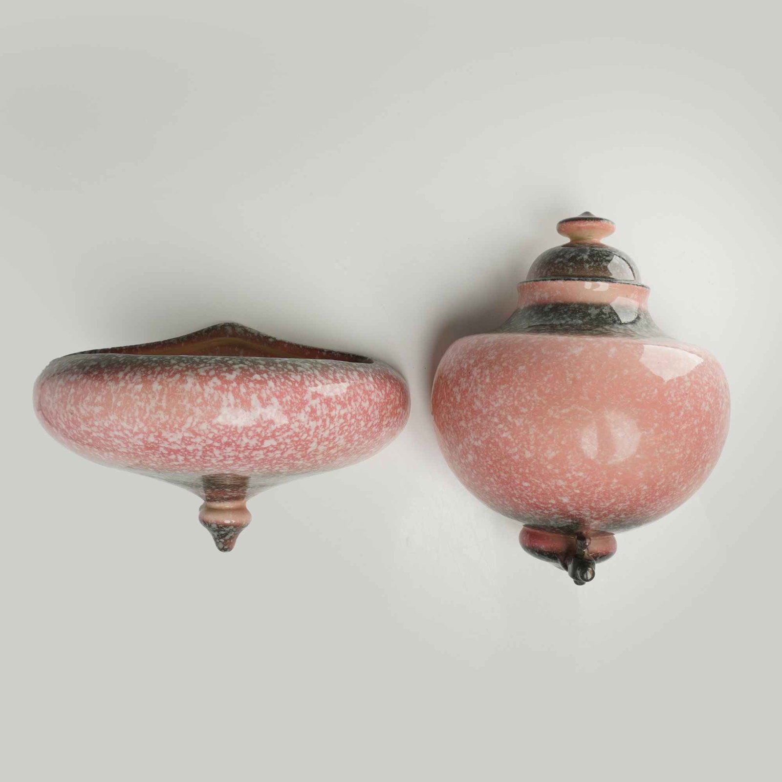 A 2pc Hull USA Pottery Tuscany Wall Fountain and Basin Planter: A two-piece Hull USA Pottery wall fountain and basin planter set in the Tuscany pattern. The ceramic pieces feature a bulbous, spinning-top form with a tapered finial base and a tiered upper section. 
