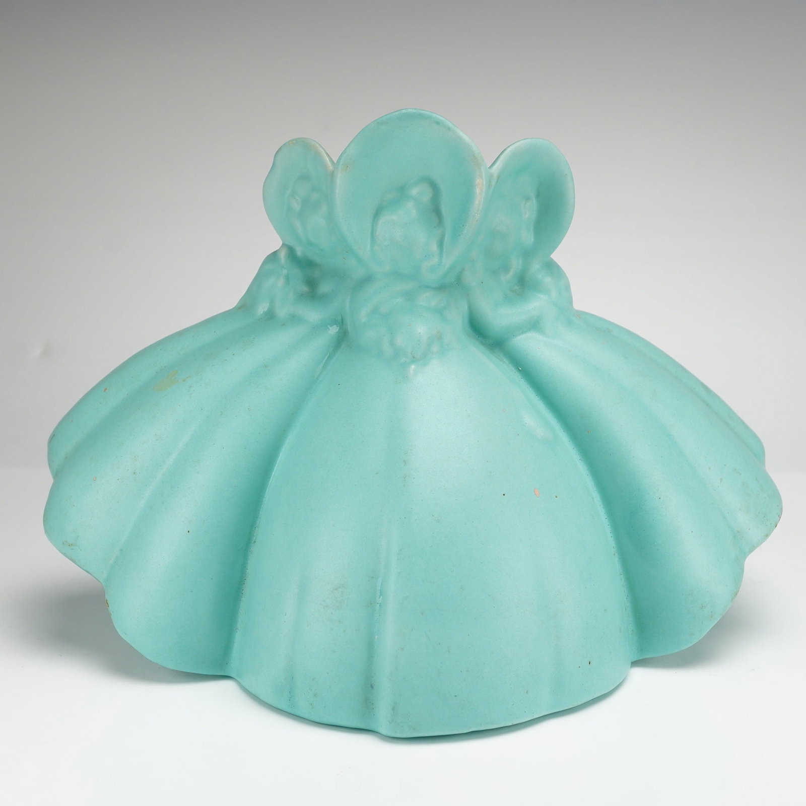 Haeger USA Pottery Victorian Ladies Vase: Haeger Pottery Victorian Ladies Vase finished in a uniform matte turquoise glaze. This figurative ceramic planter is molded with three female figures in voluminous gowns and bonnets whose joined skirt