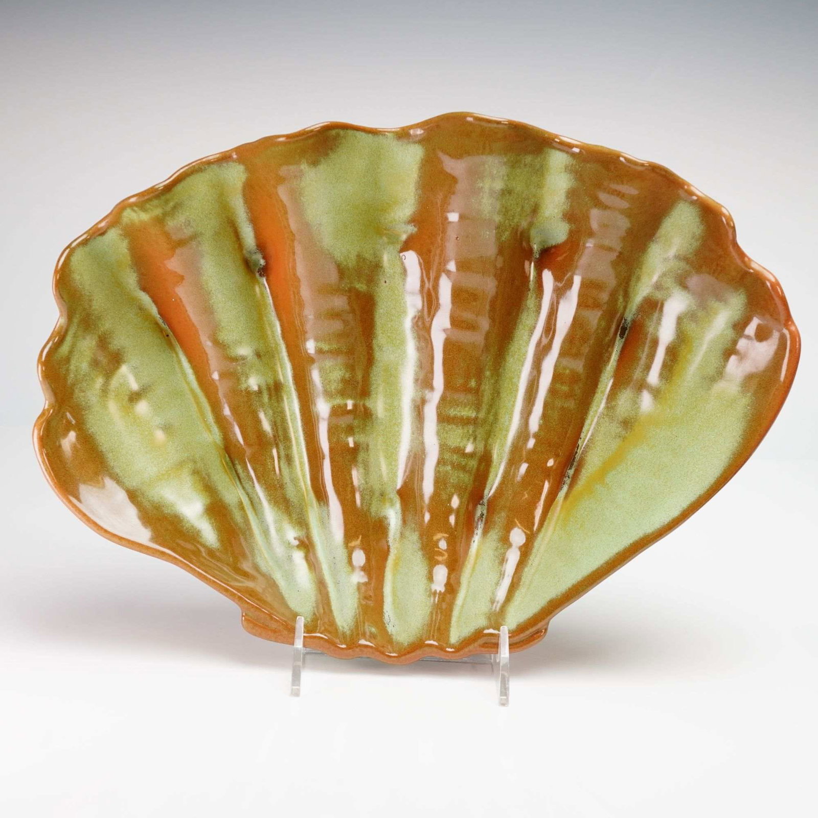 Frankoma, Prairie Green, Clam Shell Centerpiece Bowl: This large earthenware centerpiece bowl was produced by Frankoma Pottery of Sapulpa, Oklahoma. The piece is molded in the form of a giant clam or scallop shell and features the company's signature Sap