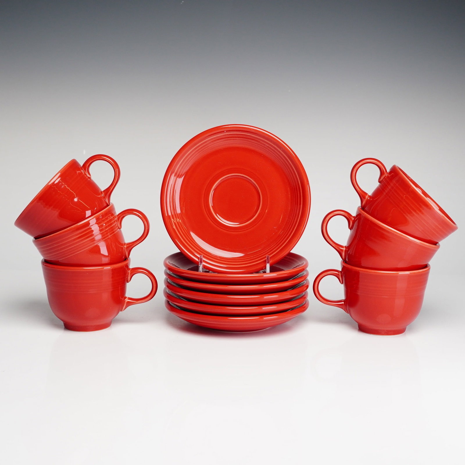 12pc Homer Laughlin Fiesta Scarlet Cups and Saucers Set: A set of six teacups and six matching saucers manufactured by the Homer Laughlin China Co. of Newell, West Virginia. These pieces are part of the contemporary Fiesta line in the Scarlet colorway, whic