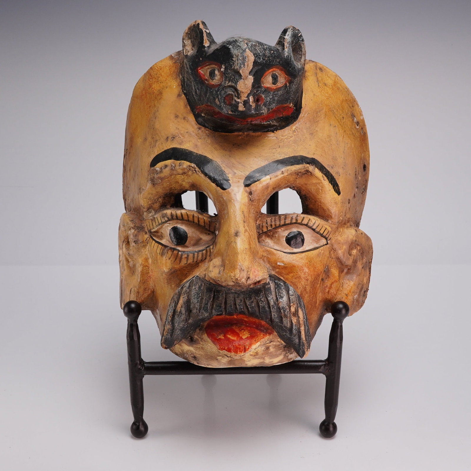 Mexican Polychrome Hand-Carved Wood Conquistador Dance Mask: This ceremonial dance mask is hand-carved from wood and finished with polychrome paint. Originating from Mexico, the piece is characteristic of ethnographic masks used in traditional community festiva