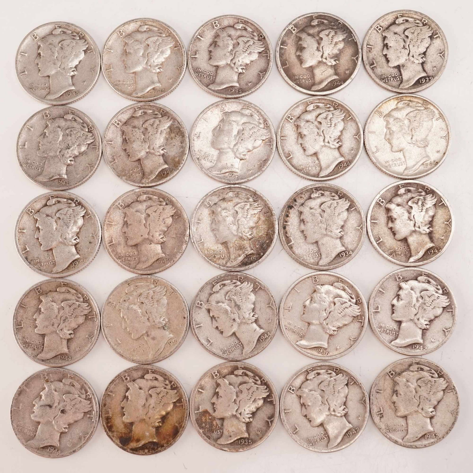 Lot of 25 Loose Mercury 90% Silver Dimes, Circulated: Obverse designed with an allegory of Liberty wearing a winged Phrygian cap (freedom of thought) is surrounded with the word "LIBERTY" and accompanied with the motto: "IN GOD WE TRUST". Reverse fasces 