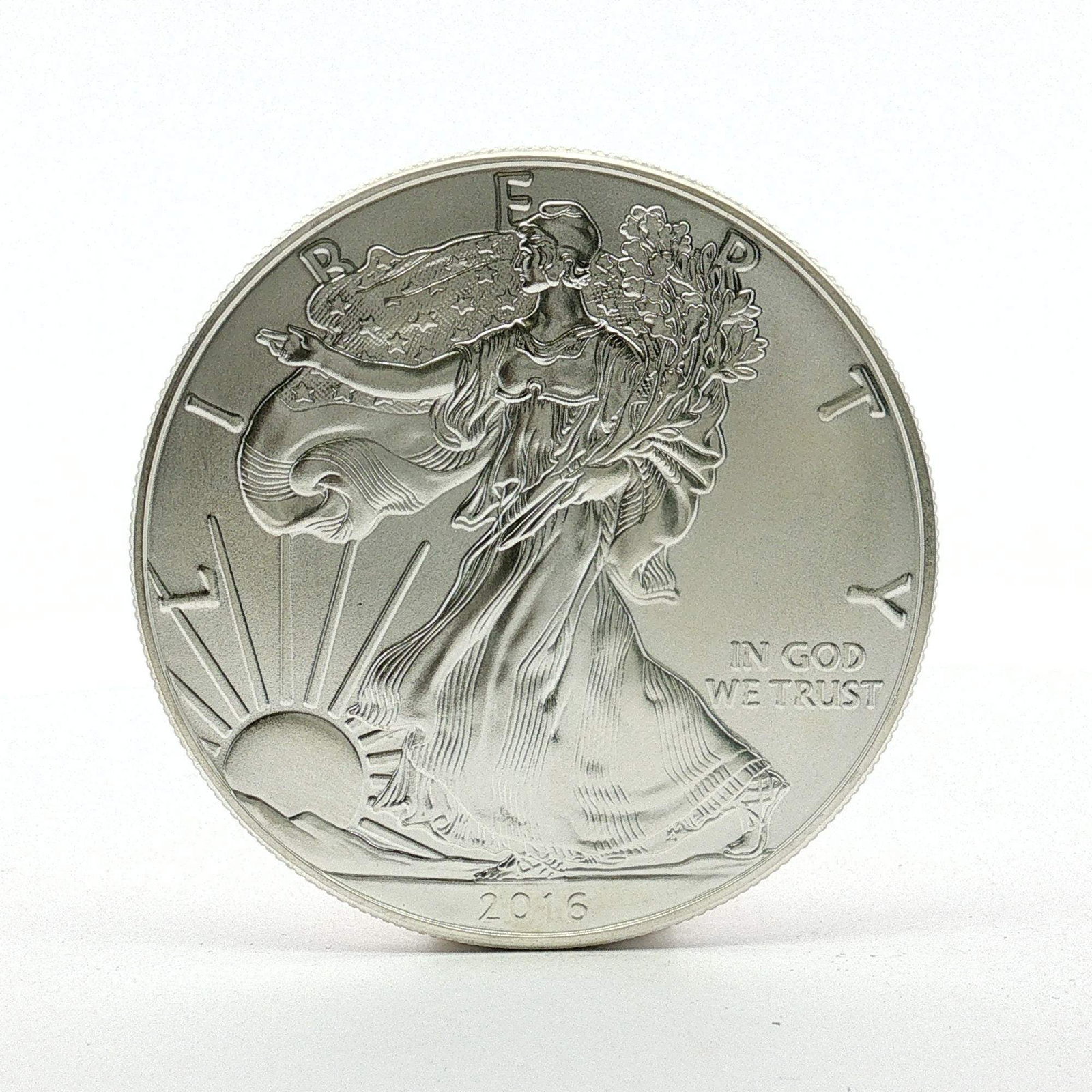 2016 U.S. American Silver Eagle One Dollar Coin: Designed with Obverse of Walking Liberty with Liberty in God We Trust 2016; reverse has heraldic eagle with shield, United States of America with 1oz. Fine Silver One Dollar. Dimensions: 40.6mm Date o