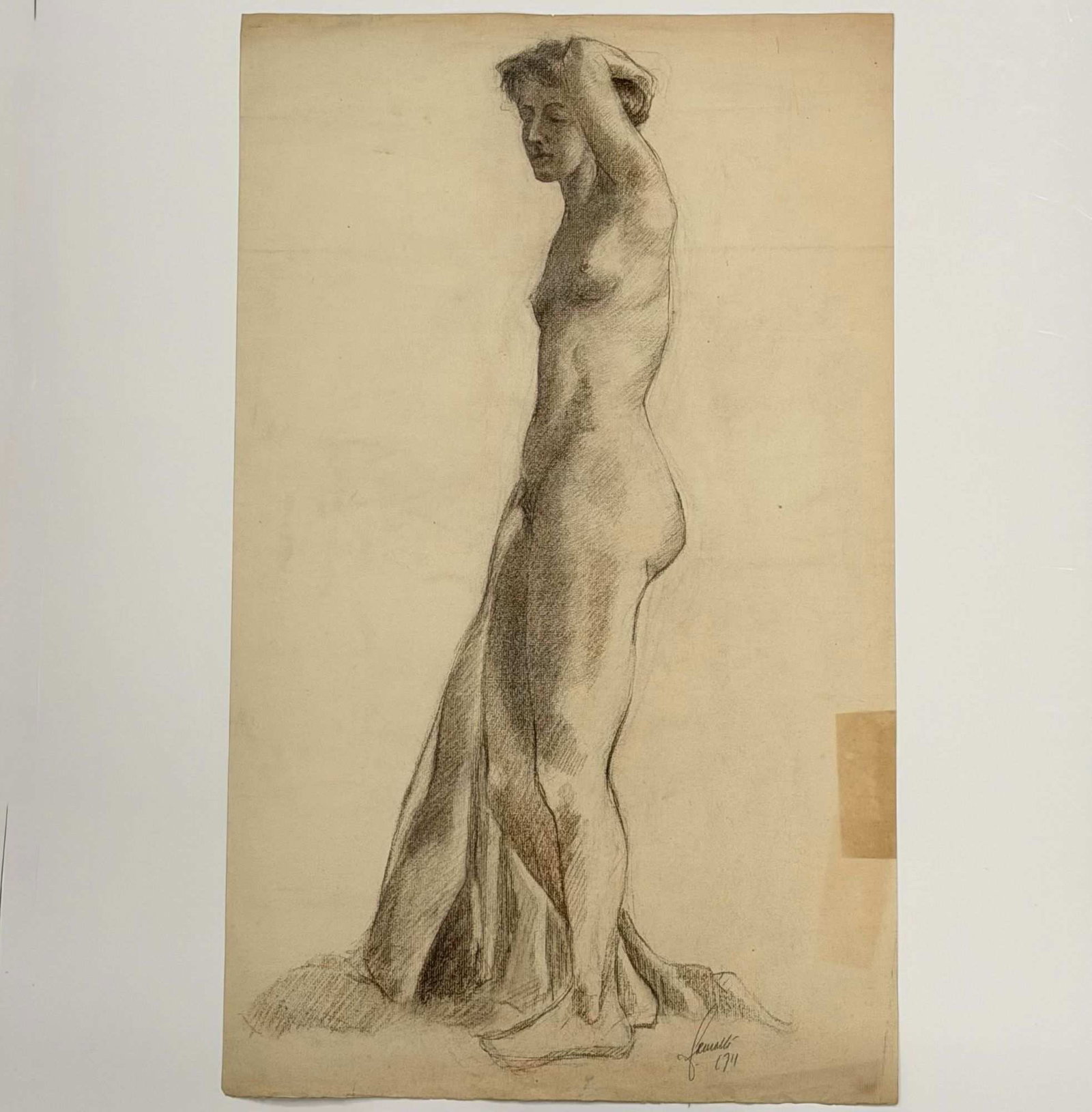 Angelo Comolli (Italian, 1863-1949), Standing Female Nude Life Study: This original graphite drawing on toned paper is an academic life study by Italian artist Angelo Comolli (1863-1949). The composition depicts a standing female nude figure in profile, with her left ar