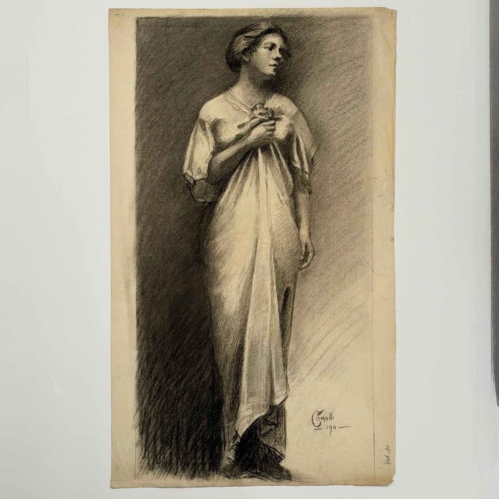 Angelo Comolli (Italian, 1863-1949), Standing Woman in Classical Dress, 1911: This original charcoal or conte crayon drawing on toned L. Berville Lalanne laid paper is by the Italian artist Angelo Comolli (1863-1949). Executed in a confident academic realist style, it depicts a