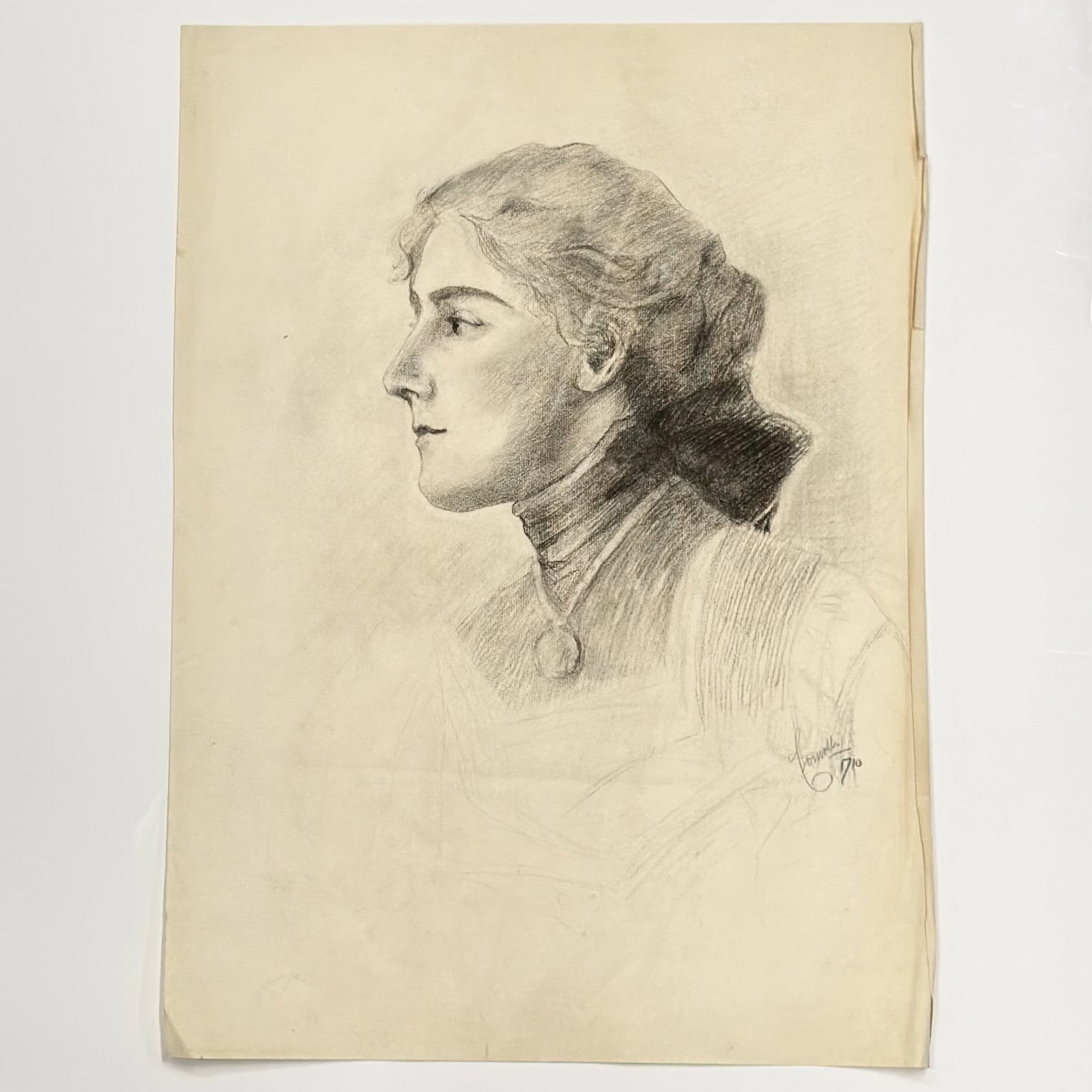 Angelo Comolli, Profile Portrait of a Woman, Graphite Drawing: This original graphite drawing on toned wove paper by Italian artist Angelo Comolli (1863??"1949) depicts a left-facing profile portrait of a woman rendered in a realist style. The subject is shown fr
