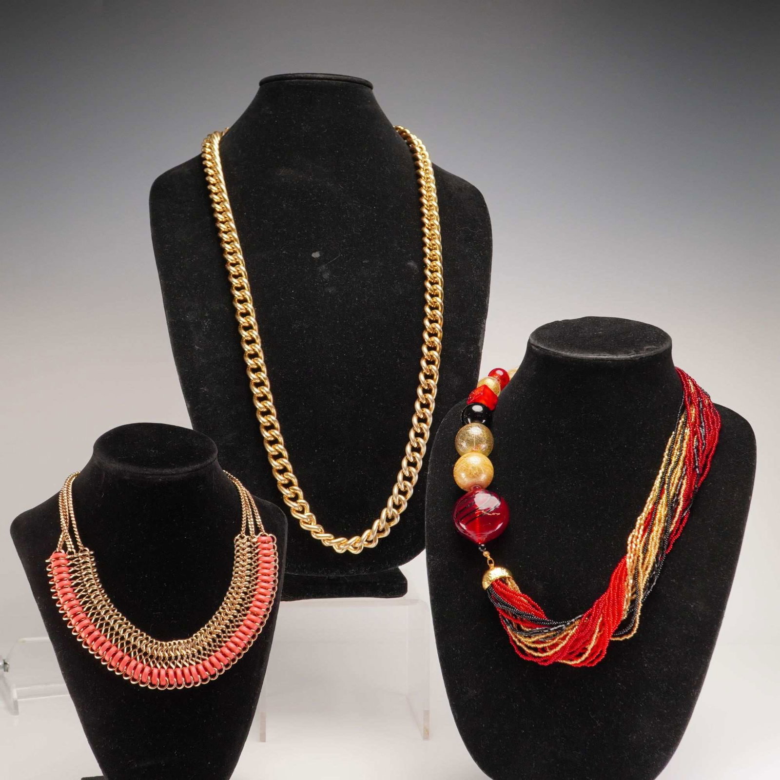 3pc Gold-Tone and Beaded Contemporary Fashion Jewelry Necklaces: This lot comprises three miscellaneous contemporary fashion jewelry necklaces featuring gold-tone metal and various colorful accents. The first piece is a long beaded tassel necklace composed of multi