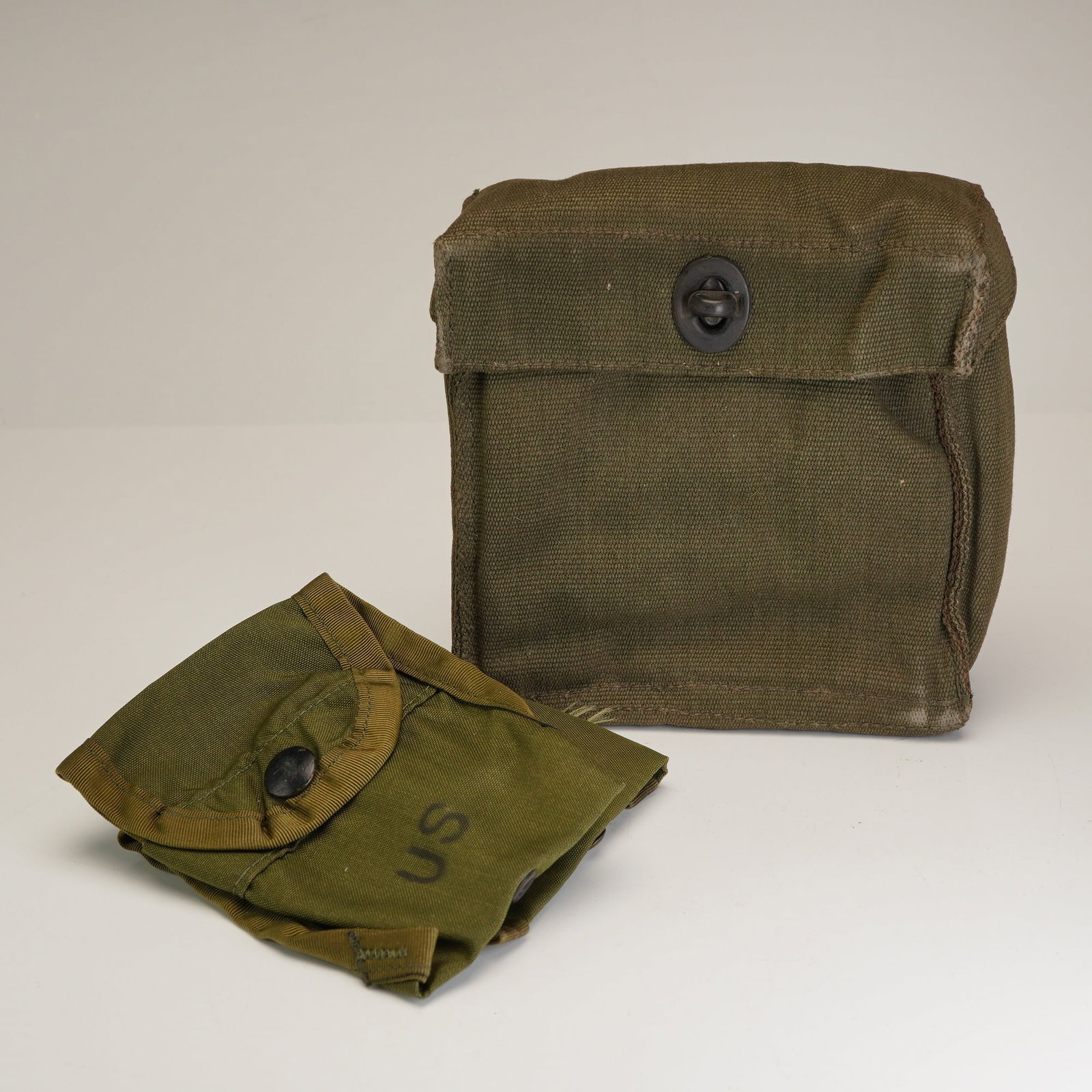Three-Piece Lot of US Military Army First Aid Surplus Pouches and British Binocular Case: This 3pc lot consists of mid-to-late 20th-century infantry field equipment from the United States and Great Britain. Included are two U.S. Military Army First Aid/Compass pouches, standard LC-1 ALICE 