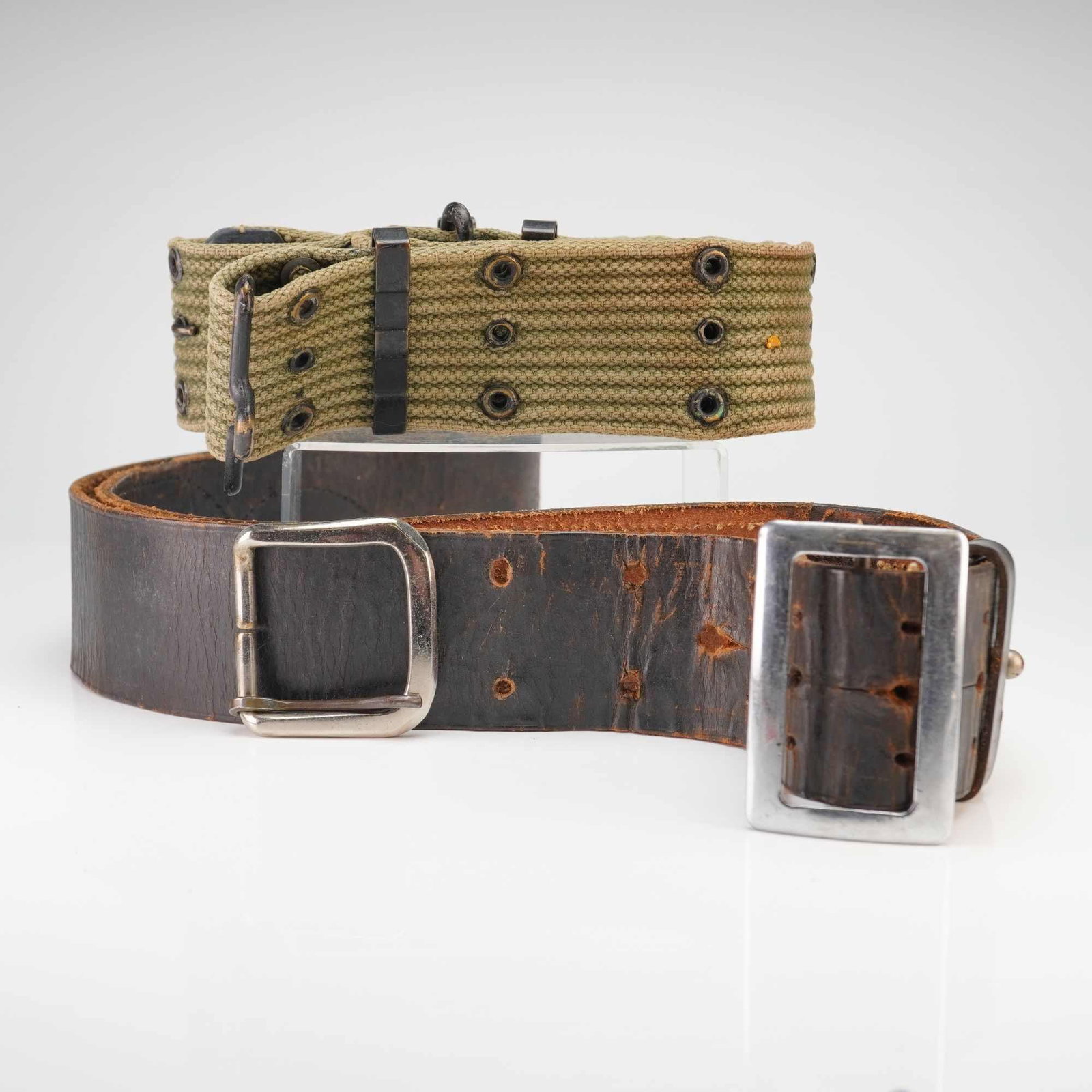 US Military Army and USMC 2pc Vintage Military Belts M1936 Pistol and M1904 Leather Trouser WWI to: This lot features a pair of authentic US military belts representing field and personal equipment from the early to mid-20th century. The first item is a World War II era US Army/USMC M1936 pistol bel
