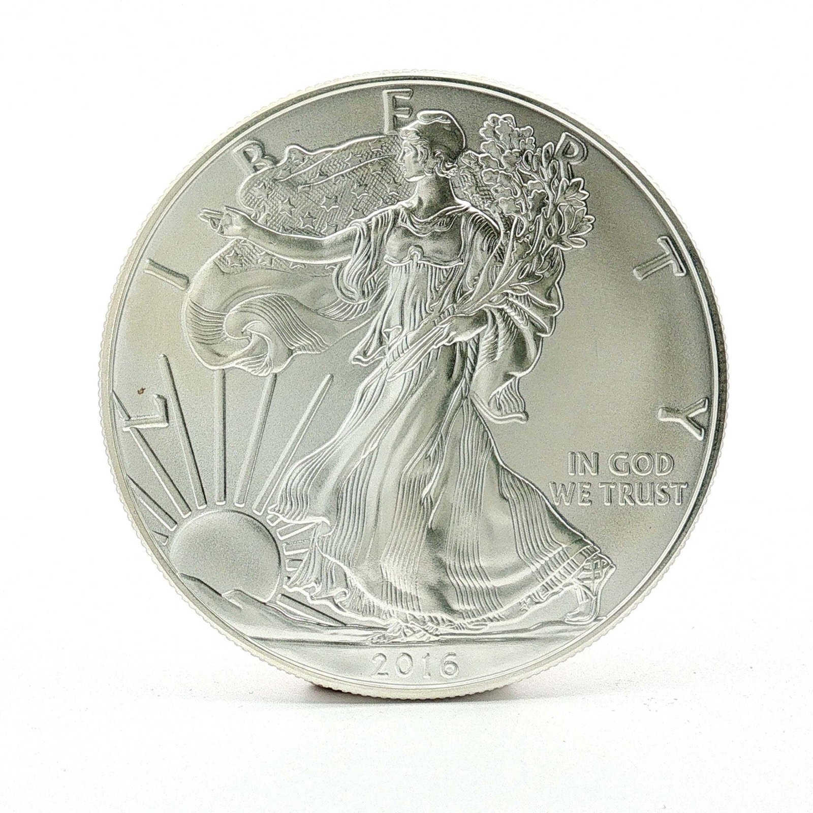 2016 U.S. American Silver One Dollar Eagle Coin: Designed with Obverse of Walking Liberty with Liberty in God We Trust 2016; reverse has heraldic eagle with shield, United States of America with 1oz. Fine Silver One Dollar. Dimensions: 40.6mm Date o