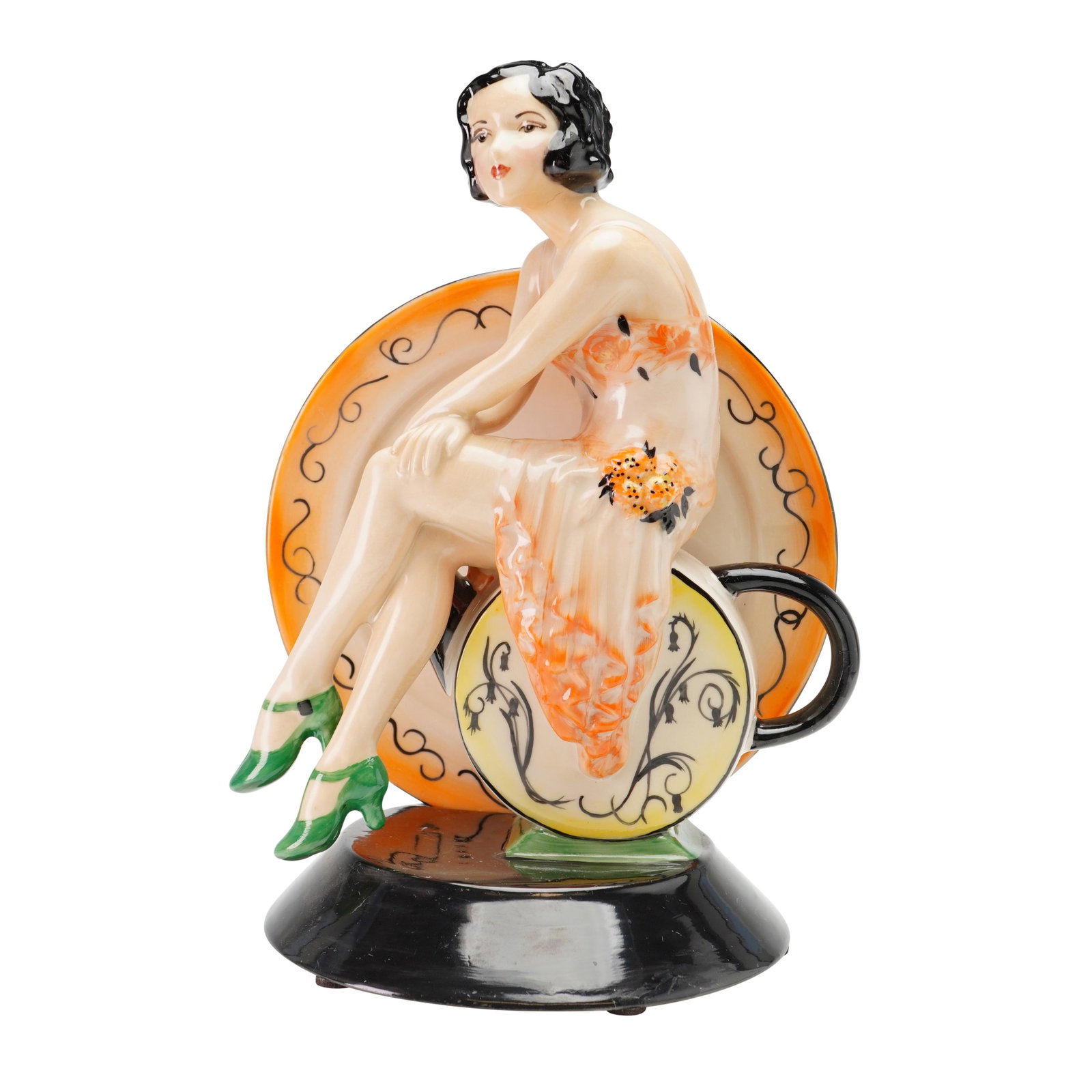 Peggy Davies by Victoria Bourne Artist's Original Proof Figurine: The hand-painted piece is executed in the Art Deco revival style and depicts a young woman with a black bobbed hairstyle. She is dressed in a sleeveless peach-colored gown decorated with orange floral