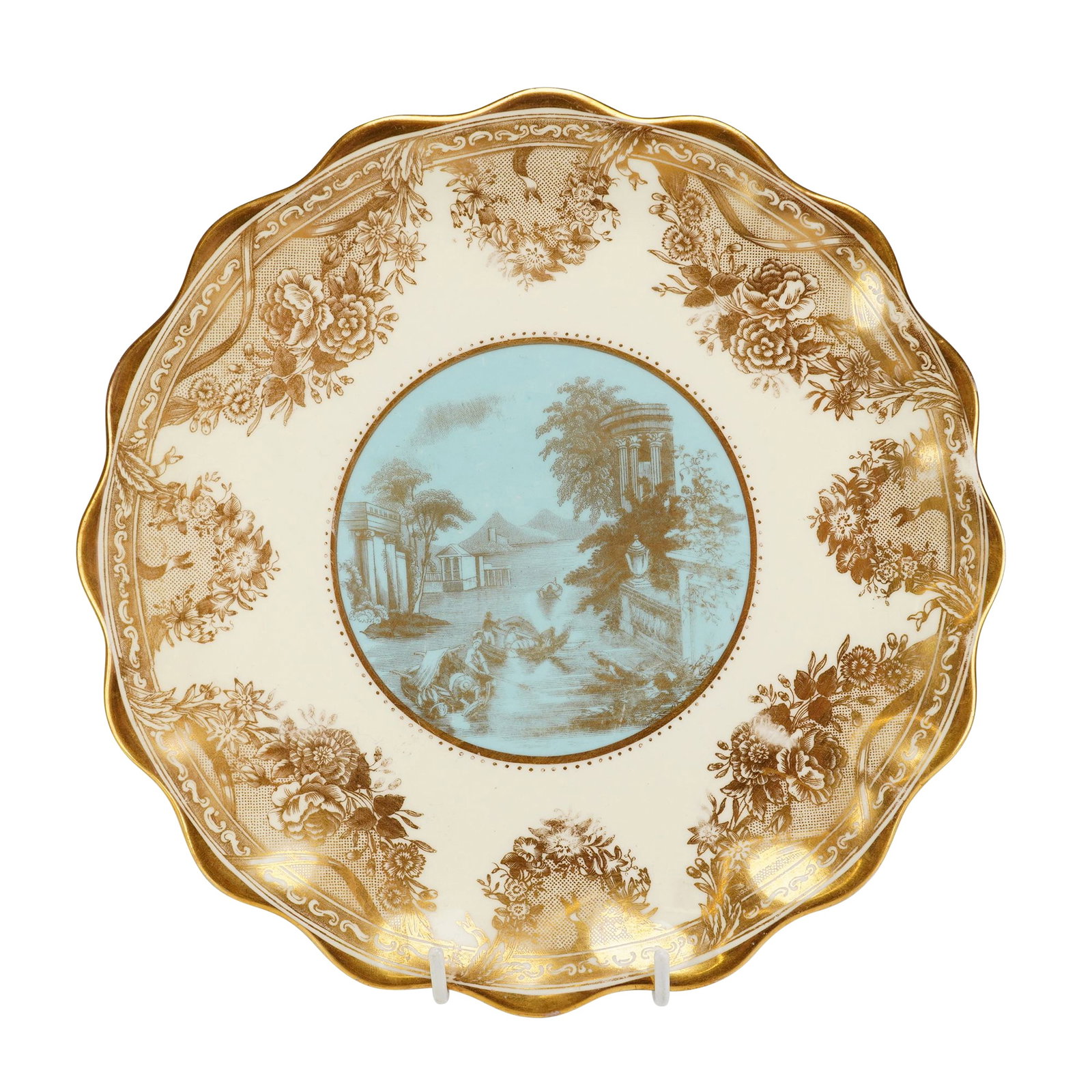 Wedgwood Gilt Porcelain Cabinet Plate, Landscape Medallion: This porcelain cabinet plate by Wedgwood features a central circular medallion with a pale blue ground and a sepia-toned classical landscape scene. The landscape depicts architectural ruins, including
