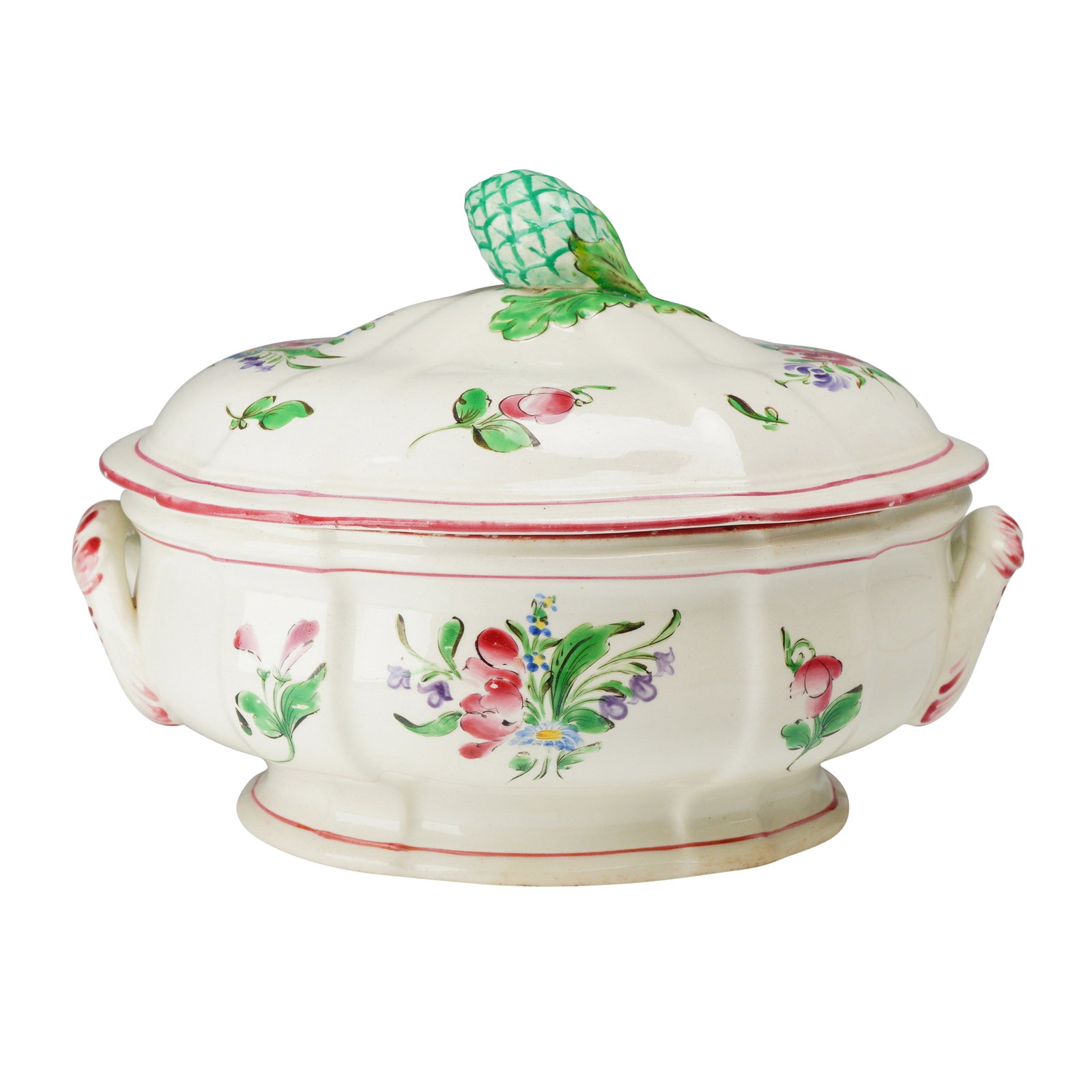 K and G Luneville Faience Lidded Soup Tureen with Artichoke Finial: A Keller and Guerin (K and G) Luneville hand-painted faience soup tureen and lid. The earthenware piece features an oval, lobed body supported by a scalloped pedestal foot. Two integrated scroll handl