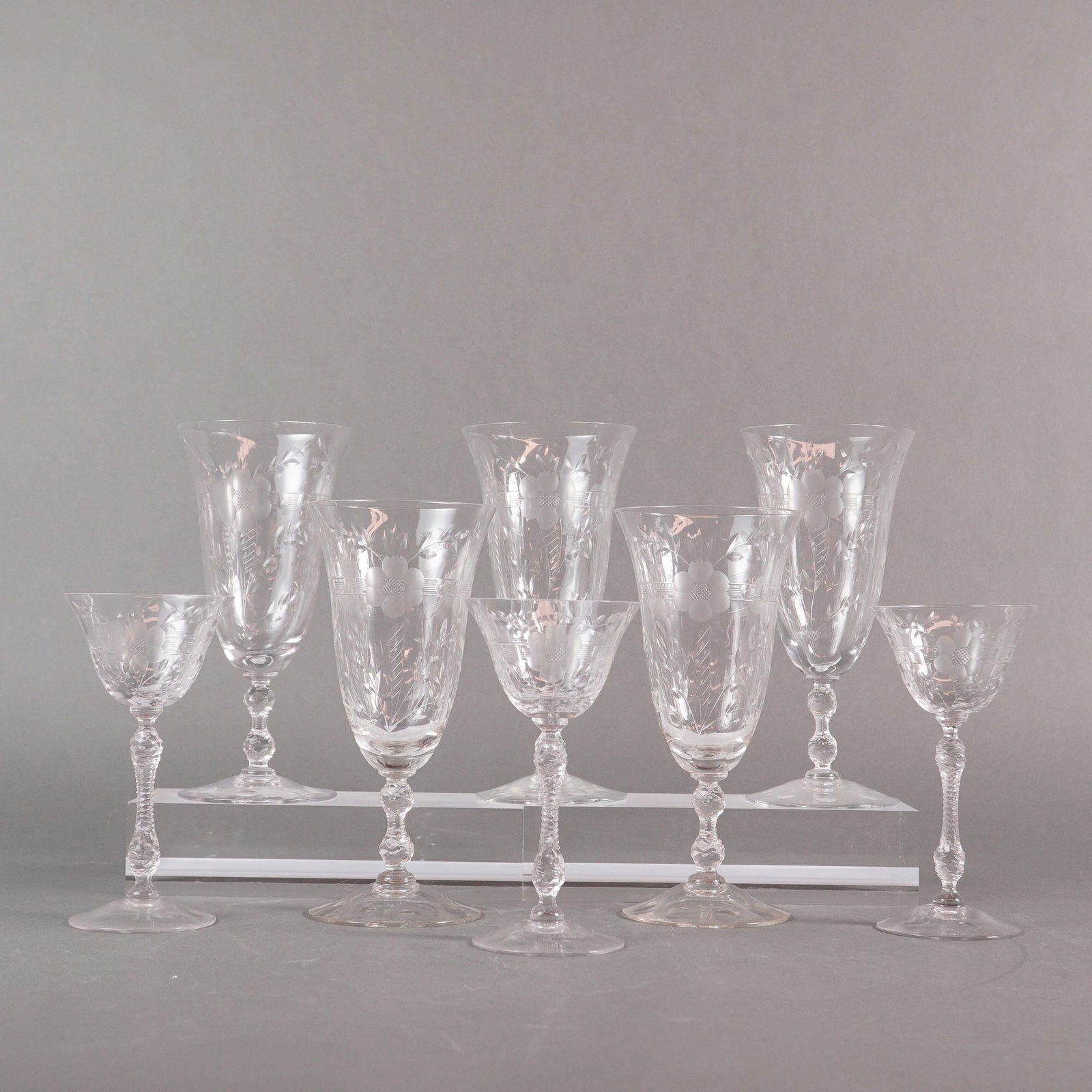 A Collection of Eight Cambridge Etched Crystal Stemware: A collection of eight (8) pieces of clear stemmed glassware, attributed to the Cambridge Glass Company, featuring the Rose Point or Lucia etched pattern. The collection consists of assorted sizes, spe