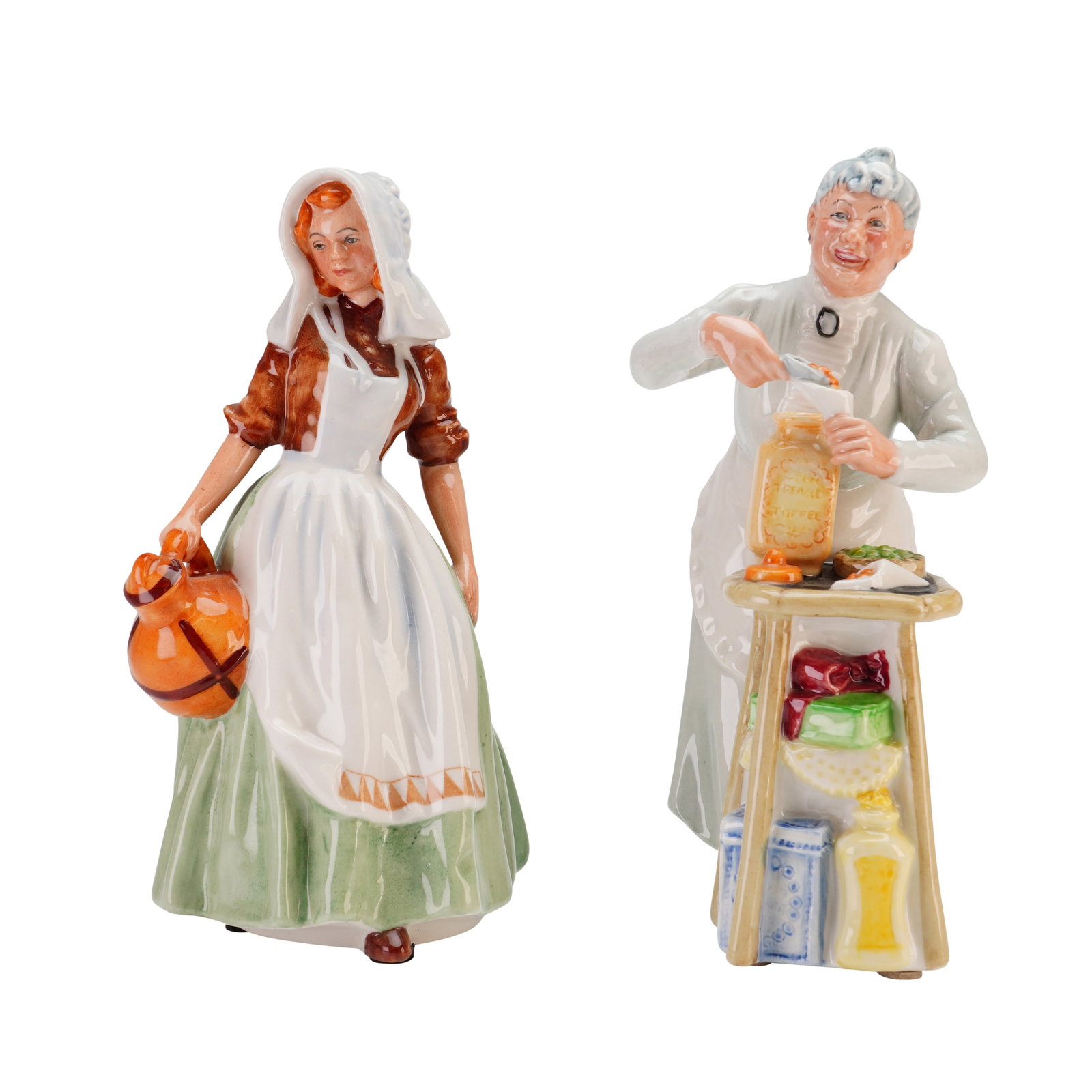 2pc Royal Doulton Porcelain Figurines, The Milkmaid and A Penny's Worth: This lot comprises two glazed porcelain figurines manufactured by Royal Doulton, England. The first figurine is titled The Milkmaid, reference HN 2057. It depicts a standing female figure wearing a wh