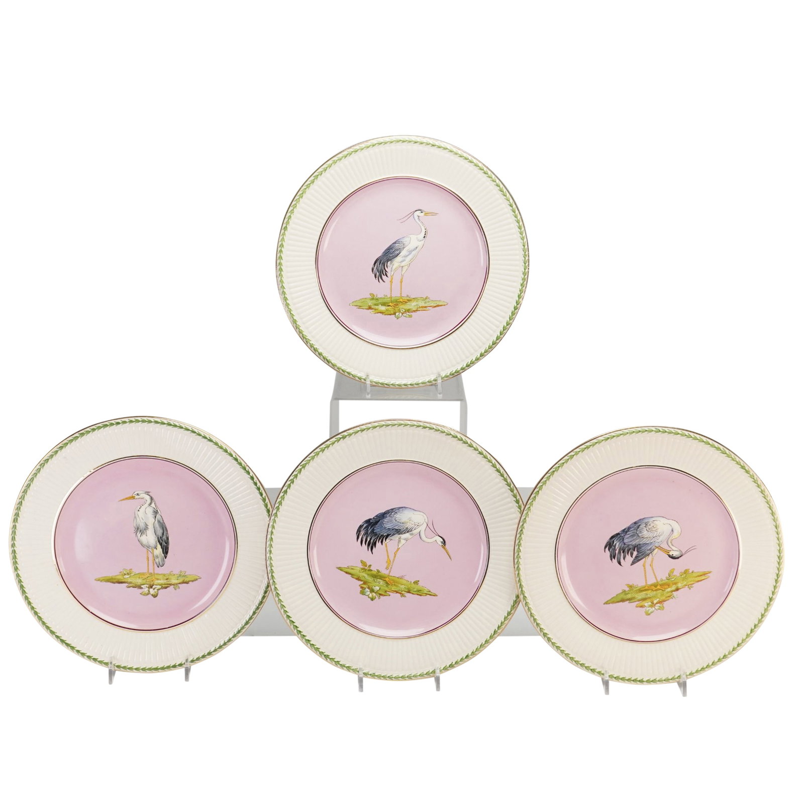 Set of Four Wedgwood Etruria Earthenware Cabinet Plates: This set of four glazed earthenware cabinet or dessert plates was produced by Wedgwood at the Etruria works in England. Each circular plate features a central pink-ground medallion depicting a heron o