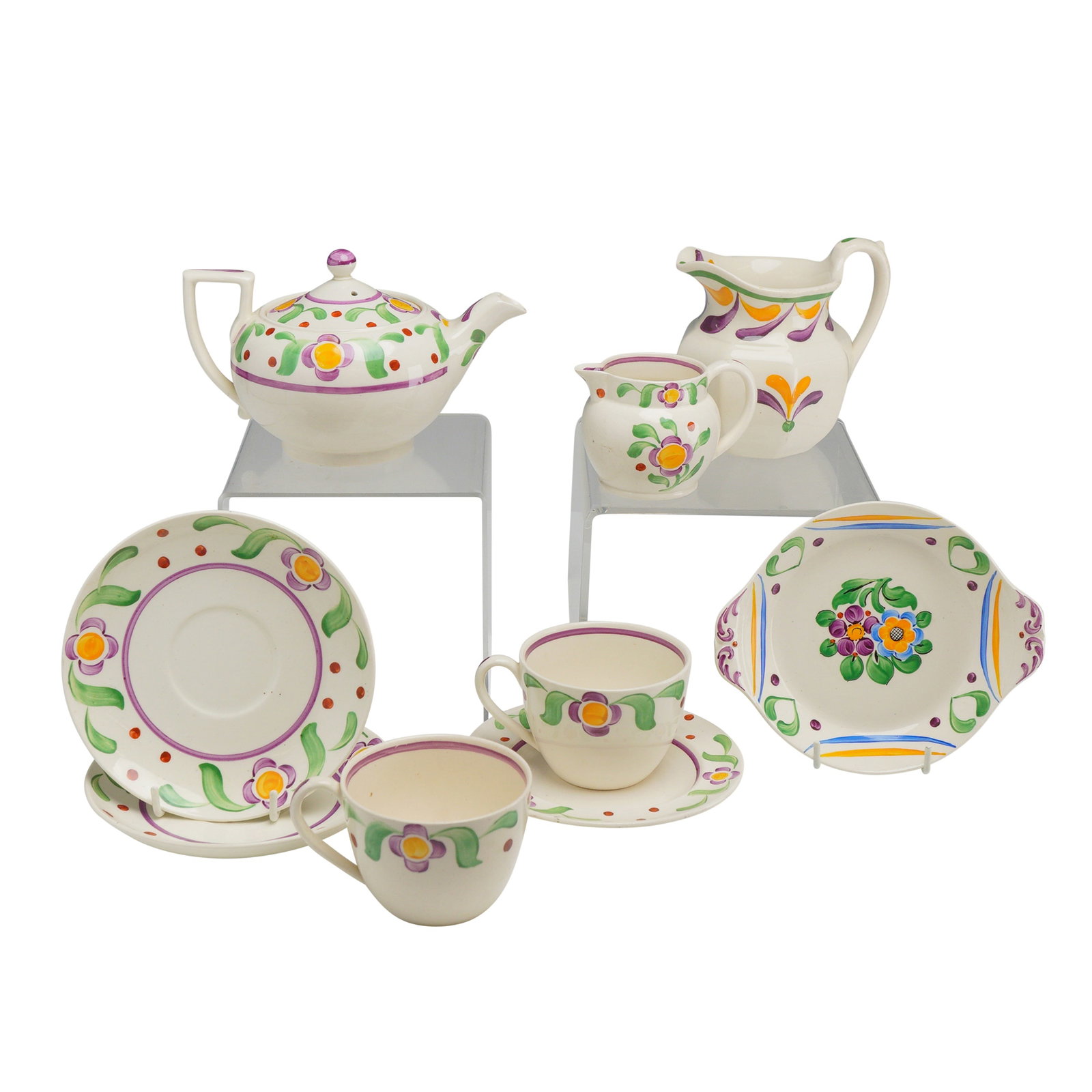 9pc Wedgwood Hand-Painted Ceramic Tea and Service Pieces: This collection of Wedgwood ceramic tea and service pieces features hand-painted floral decoration on a cream-colored earthenware body. The set is decorated in an Art Deco-influenced cottage style, ch