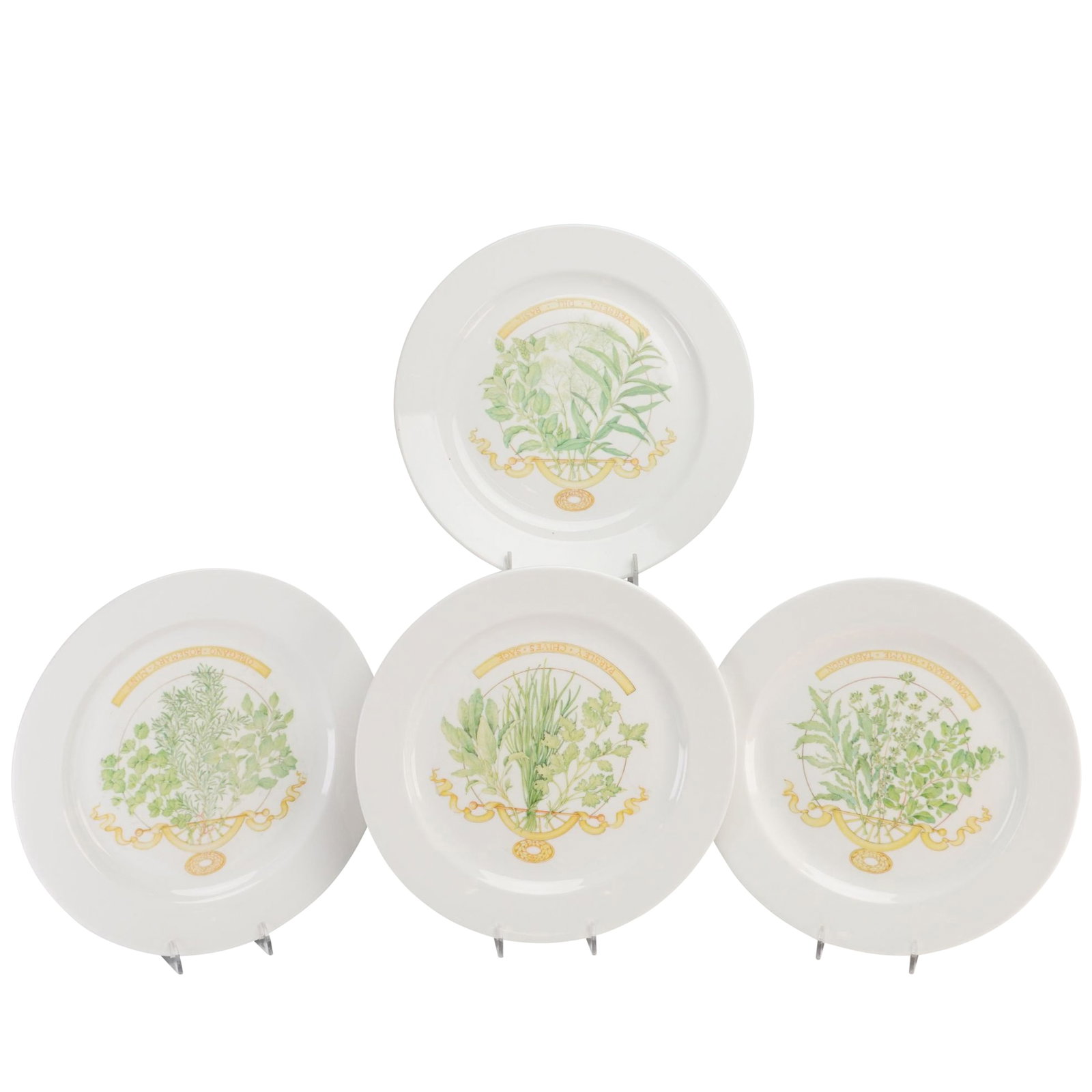 Set of Four Wedgwood Bone China Botanical Herb Sample Plates: This set of four bone china plates was manufactured by Wedgwood in England, circa 2000. Each circular plate features a central polychrome botanical illustration of a group of three herbs tied with a r