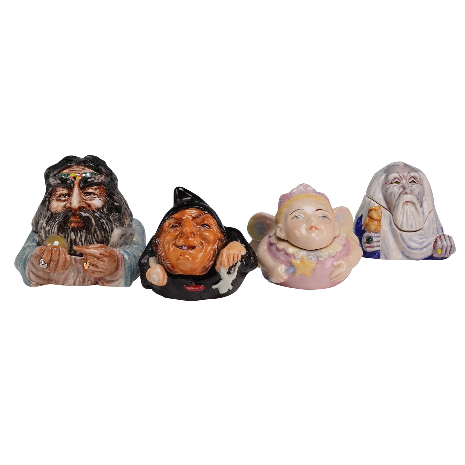 Set of 4 Kevin Francis Face Pot Trinket Boxes including Wizard Prototype and Limited Edition: A set of four hand-painted glazed ceramic miniature trinket boxes from the Face Pots collection by Kevin Francis. Each item consists of a base and a removable lid that completes the head of the charac