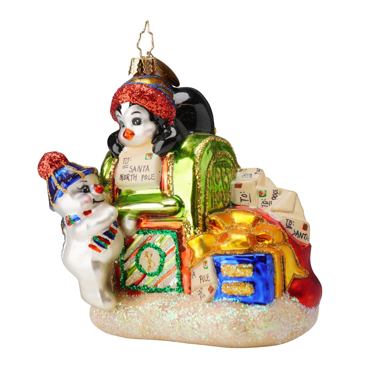 Christopher Radko Christmas Tree Ornament, Wishlist: This Christopher Radko "Wishlist" glass Christmas ornament features a vibrant holiday scene centered around a green mailbox, a red gift bag, and a blue gift box wrapped in a bright yellow ribbon. Perc