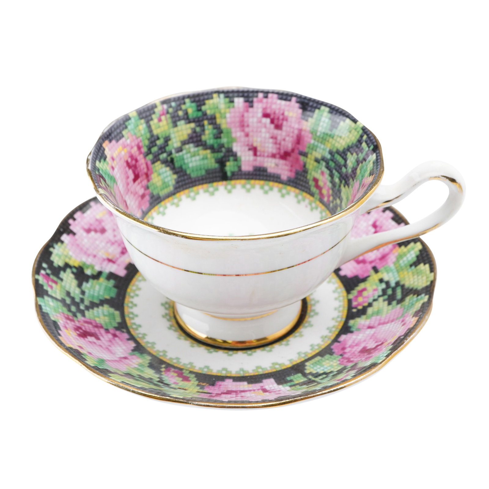 Royal Albert Porcelain Cup & Saucer Set, Needle Point: A charming cup and saucer set in the Needle Point pattern. The design features a cross-stitch-style motif of vibrant pink roses and green foliage set against a dark ground, bordered in fine gold gilt.