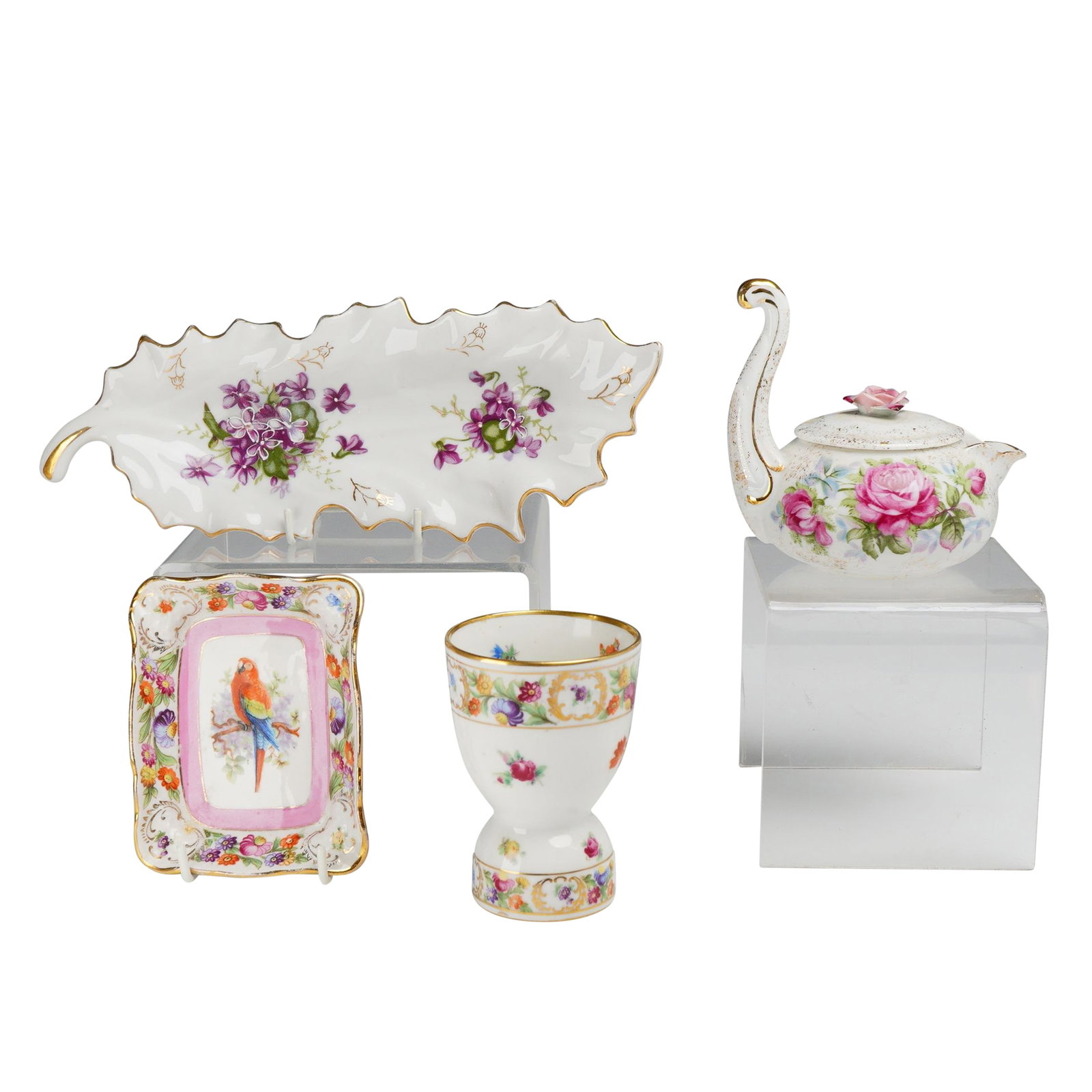 4pc Porcelain Items including Lefton and Shumann Empress: This lot of 4 porcelain items features a variety of hand-painted decorative cabinet pieces. Included is one Lefton hand painted floral teapot with lid, designed with a handle shaped like a swan neck a