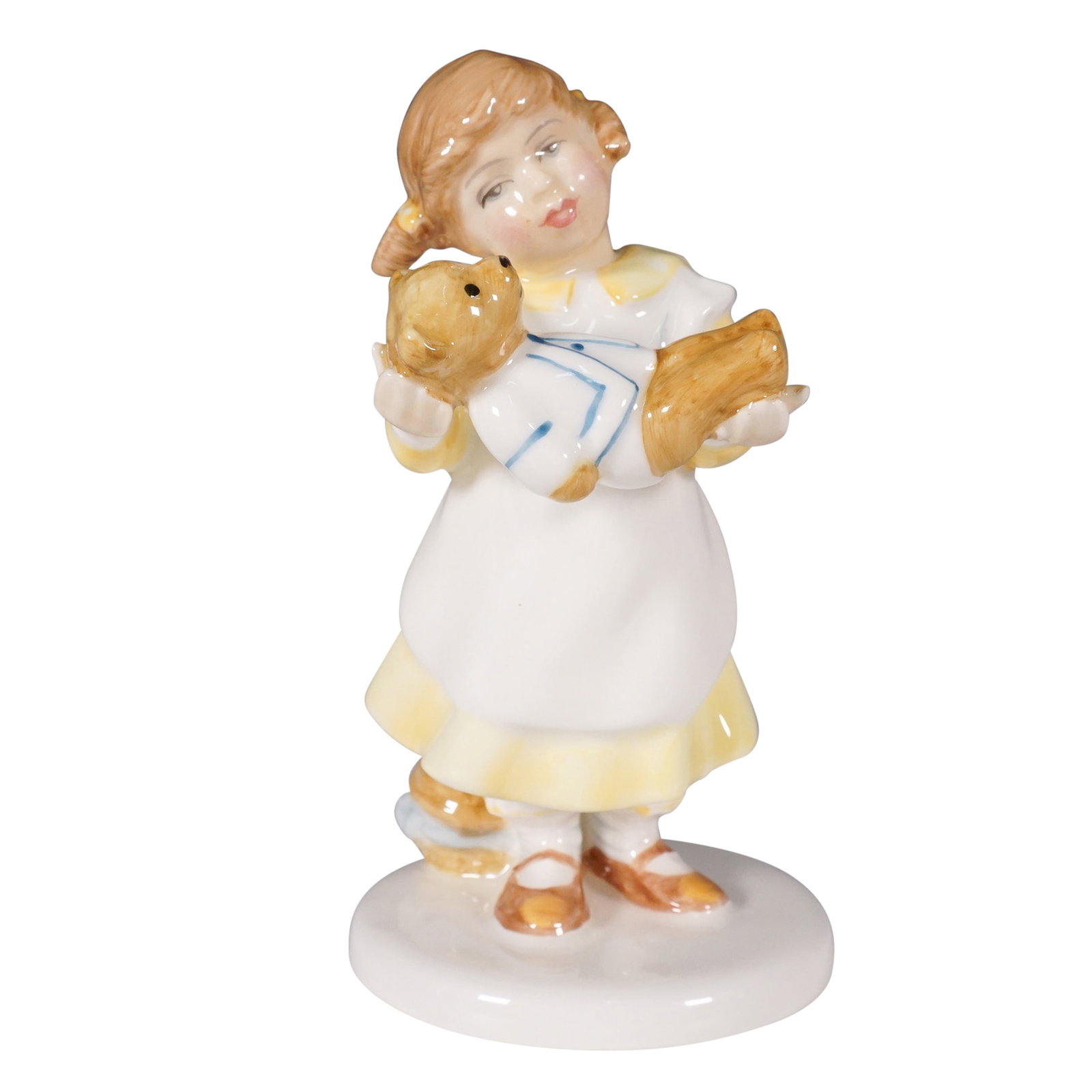 Royal Doulton Figurine, What's The Matter? HN3684: This delightful piece is part of the beloved Child Study series, capturing a young girl tenderly holding a teddy bear. Designed with intricate hand painted details, it features a glossy finish with so