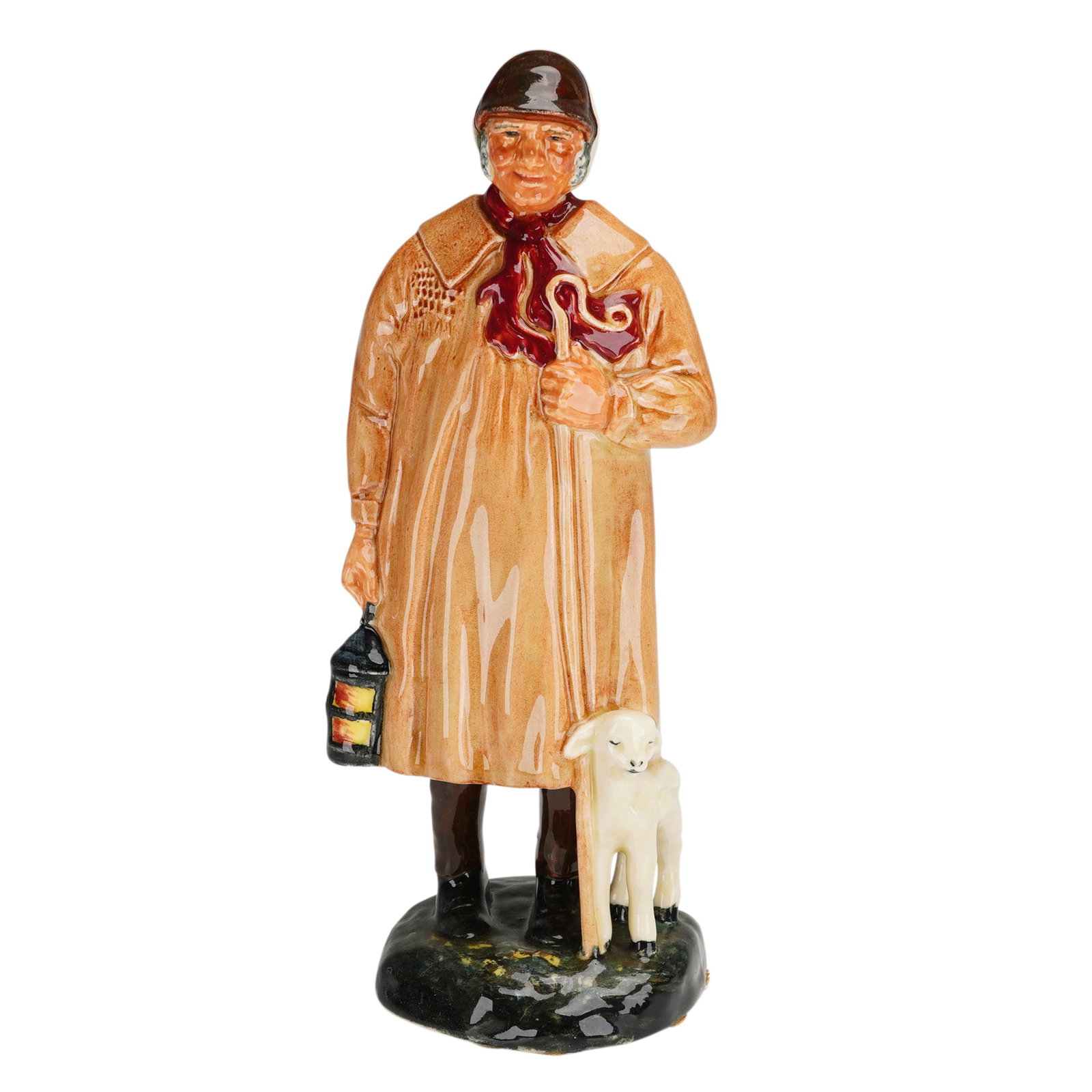 Royal Doulton The Shepherd HN1975 Figurine: A Royal Doulton glazed ceramic figurine titled The Shepherd, model number HN1975. The piece depicts a standing male figure in a long tan smock with a red neckerchief and brown cap, holding a shepherd'