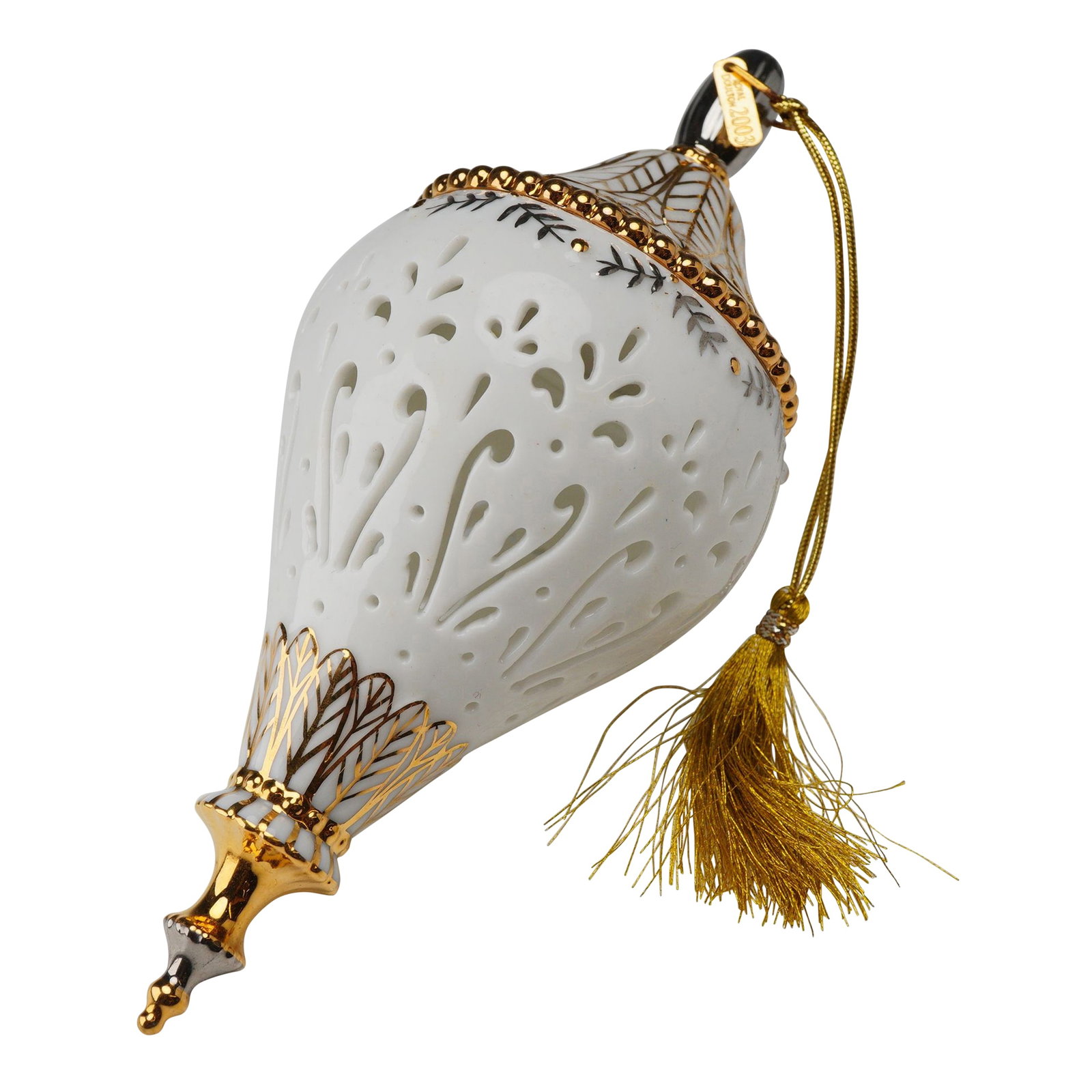 Royal Doulton 2003 1st Annual Christmas Tree Ornament: This white bone china and gilt Royal Doulton 2003 1st Annual Christmas Tree Ornament is designed in a smooth, tapered teardrop shape. The upper portion of the ornament features pierced, reticulated fl